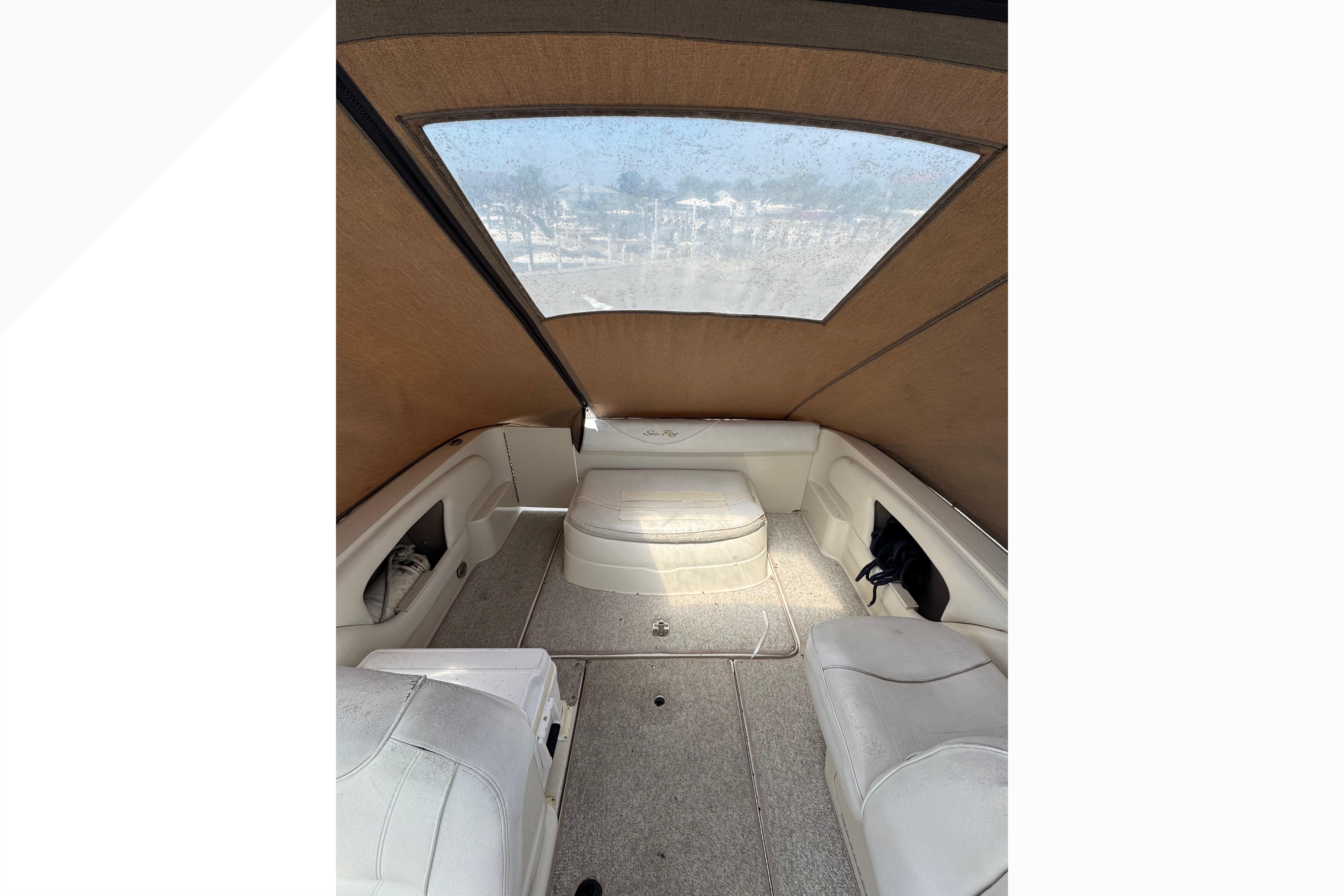 Interior view of 2001 Sea Ray 245 Weekender boat with seating and canopy.