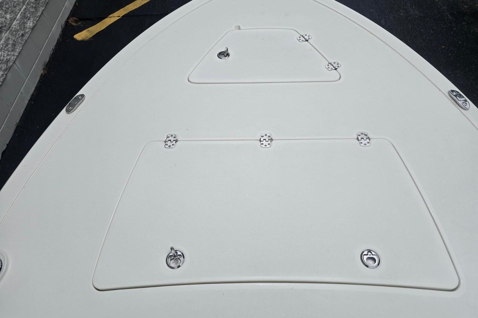 Bow deck of 2026 Mako 18 Pro Skiff boat with storage hatches.