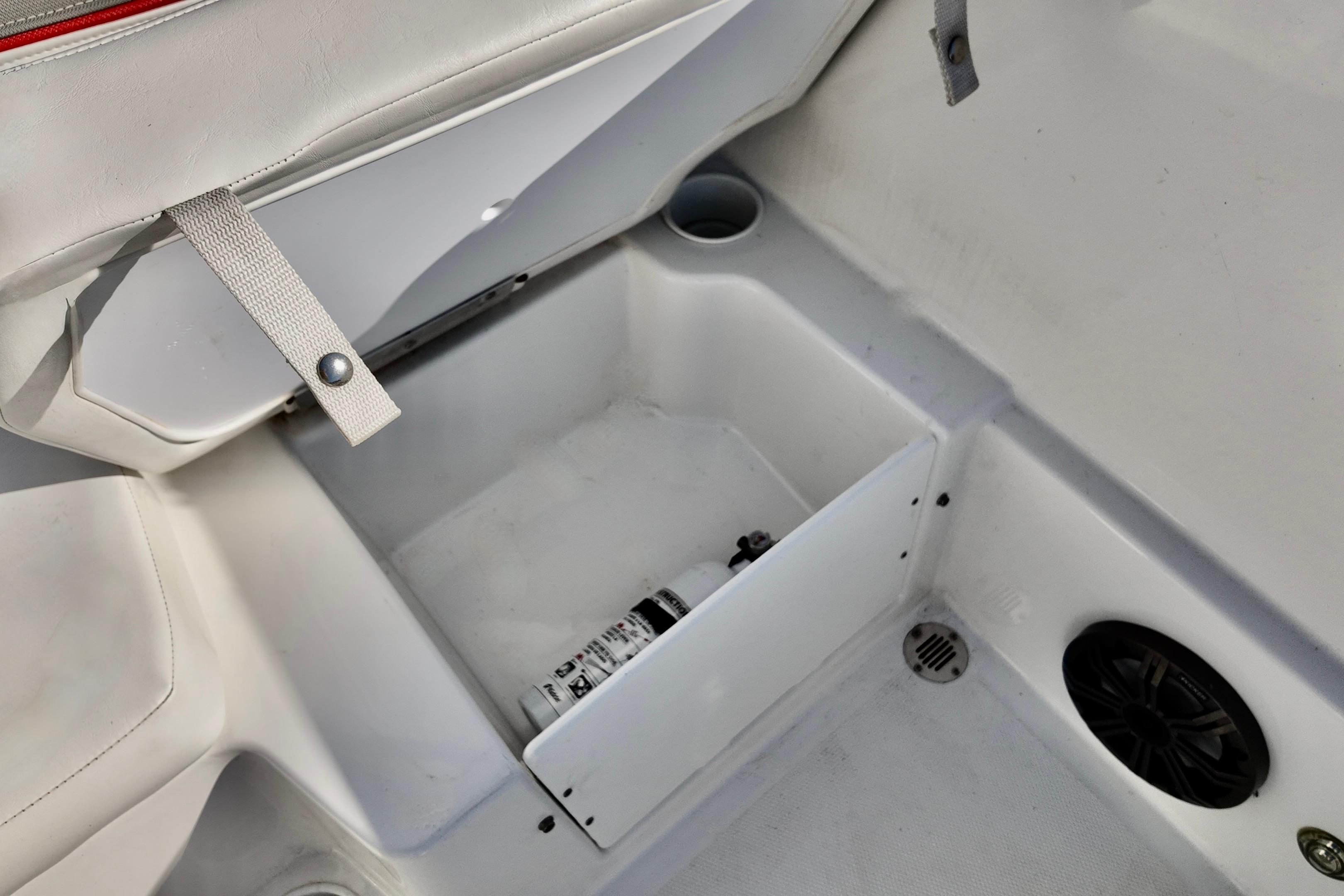 2024 Tahoe T18 boat interior storage compartment with fire extinguisher and speaker.