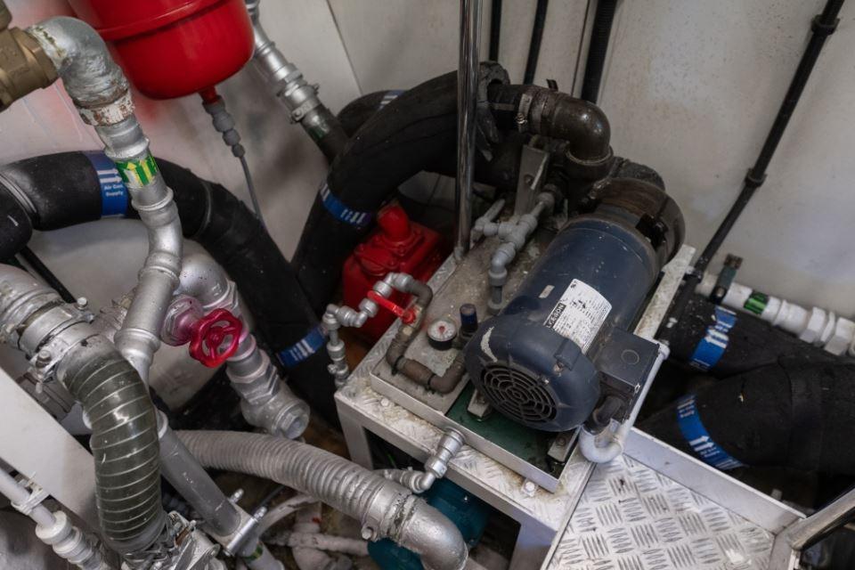 Engine room of 2009 Sunseeker 34 Metre Yacht with pipes and machinery.