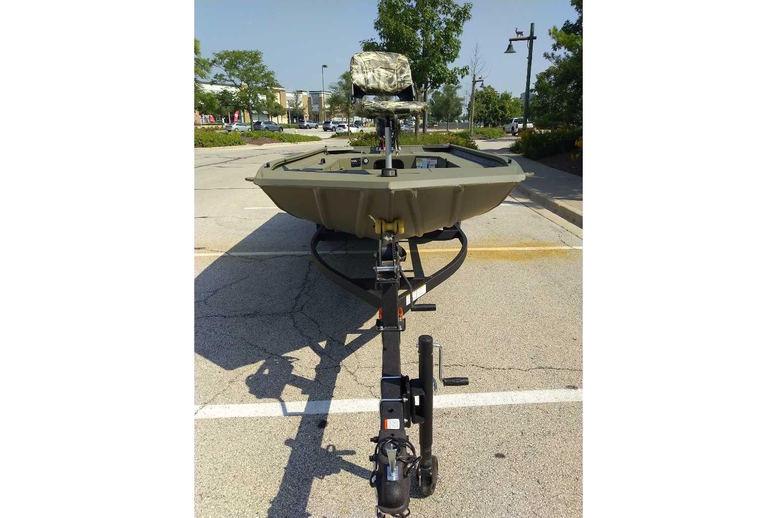 2026 Tracker Grizzly 1654 T Sportsman boat on trailer in parking lot.