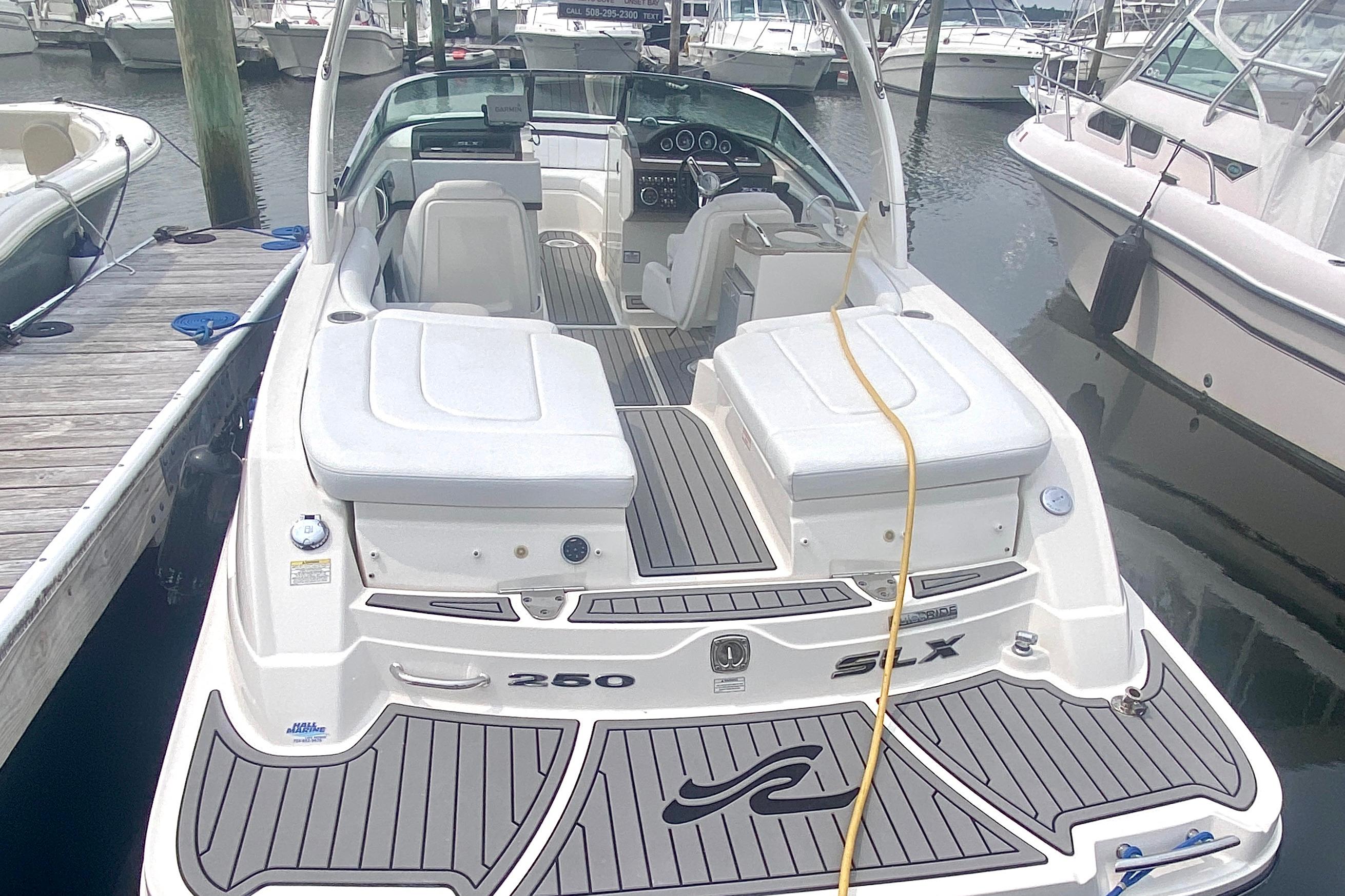 2015 Sea Ray 250 SLX boat docked in marina, rear view.