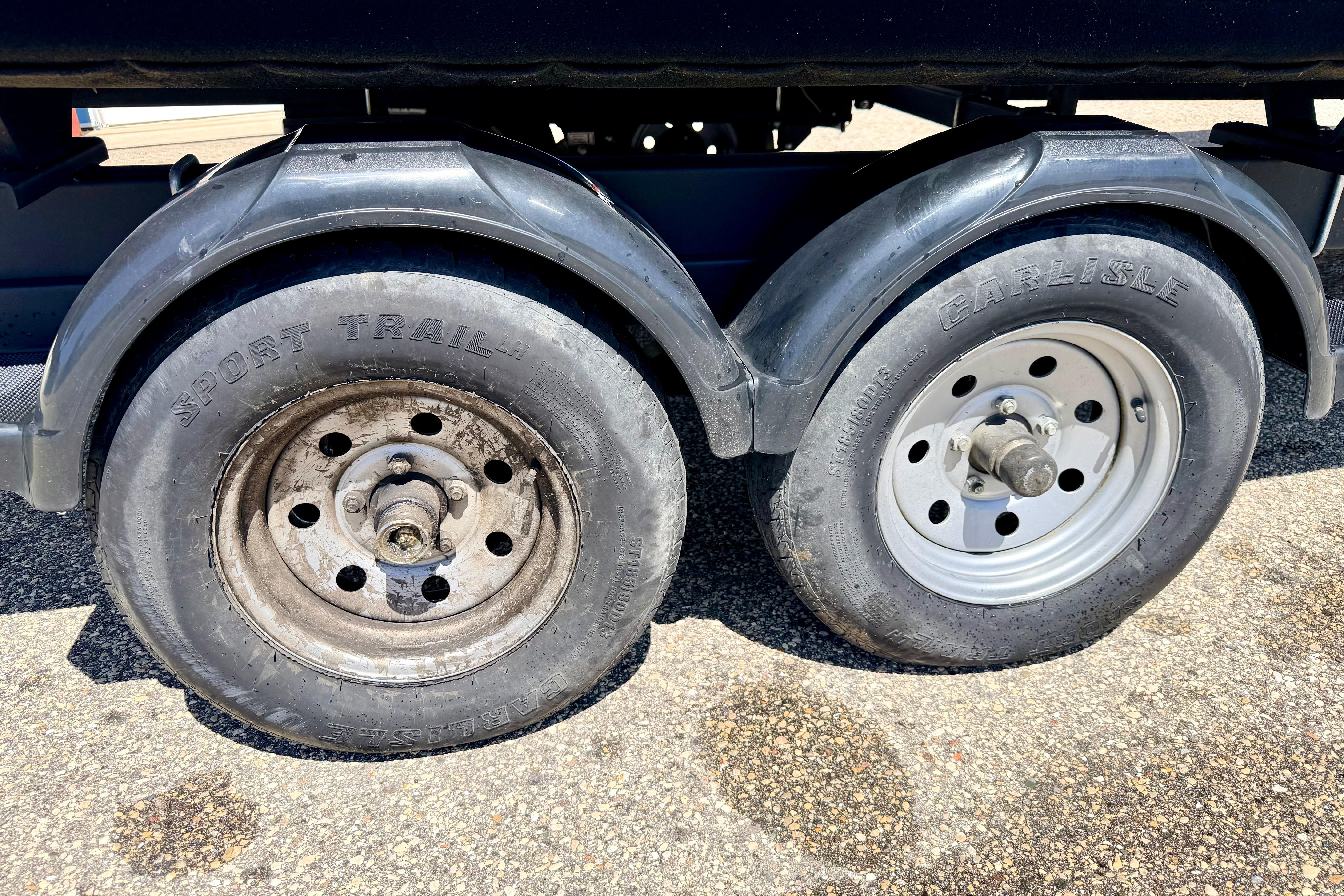 Trailer wheels of a 2019 Crestliner 240 Rally DX CW, featuring Sport Trail and Carlisle tires.