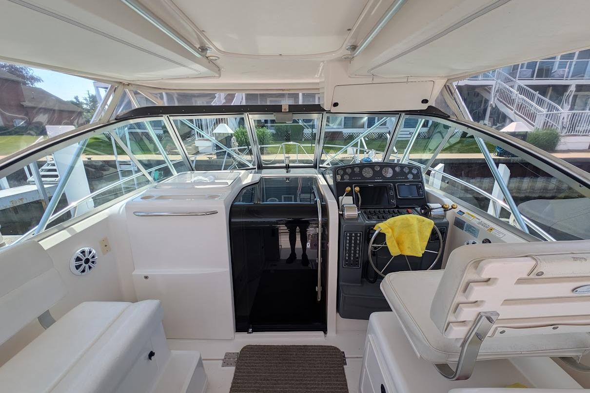 Cockpit view of 2000 Pursuit 3400 Express boat with helm and seating area.