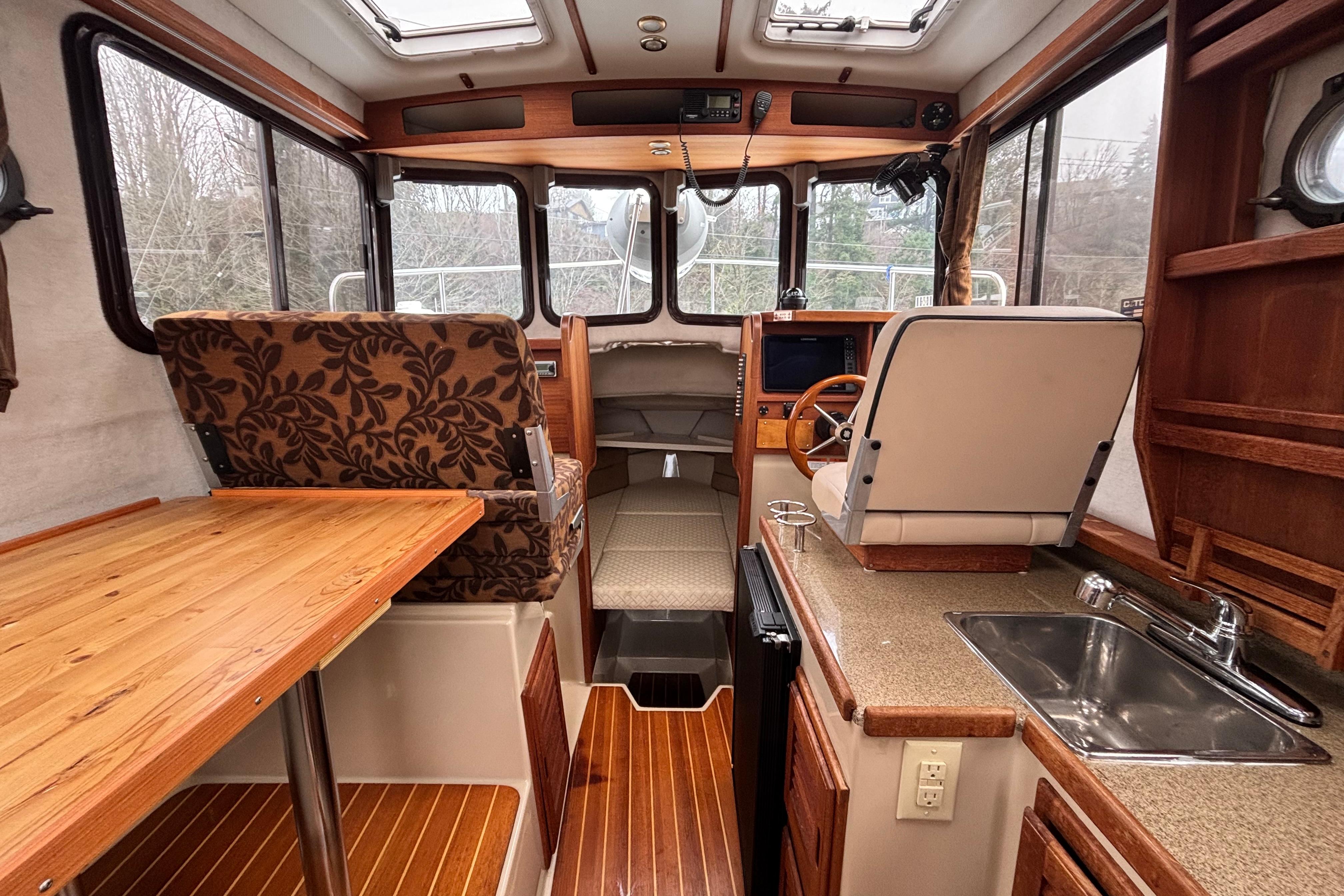 Interior of 2010 Ranger Tugs R-25 SC boat with wood accents and modern amenities.