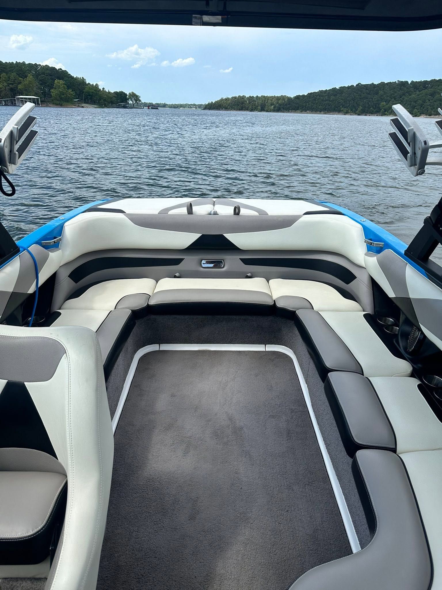 Interior of a Malibu Wakesetter 23 LSV boat on a calm lake.