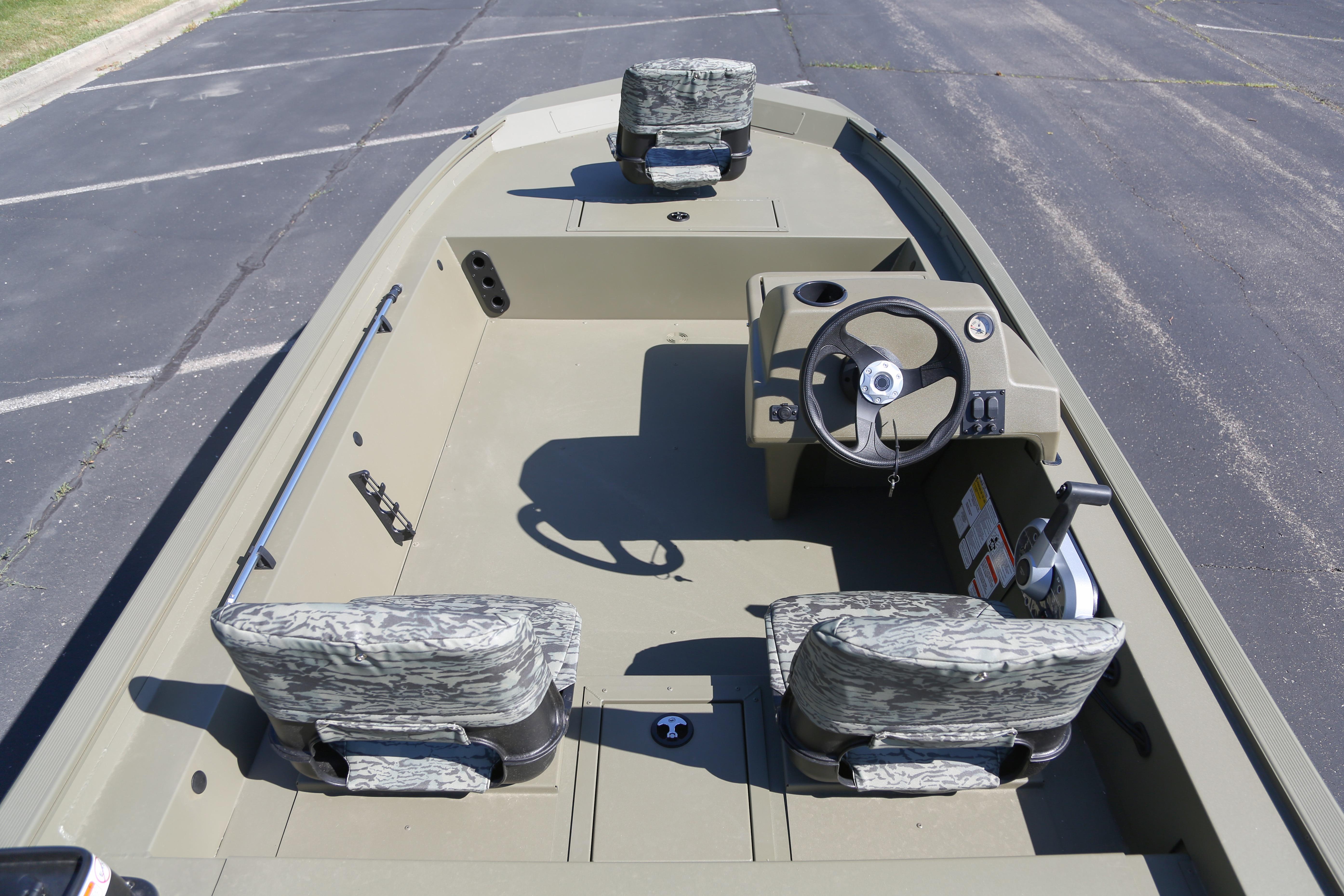 2026 Tracker Grizzly 1754 SC boat interior with camo seats and steering console.