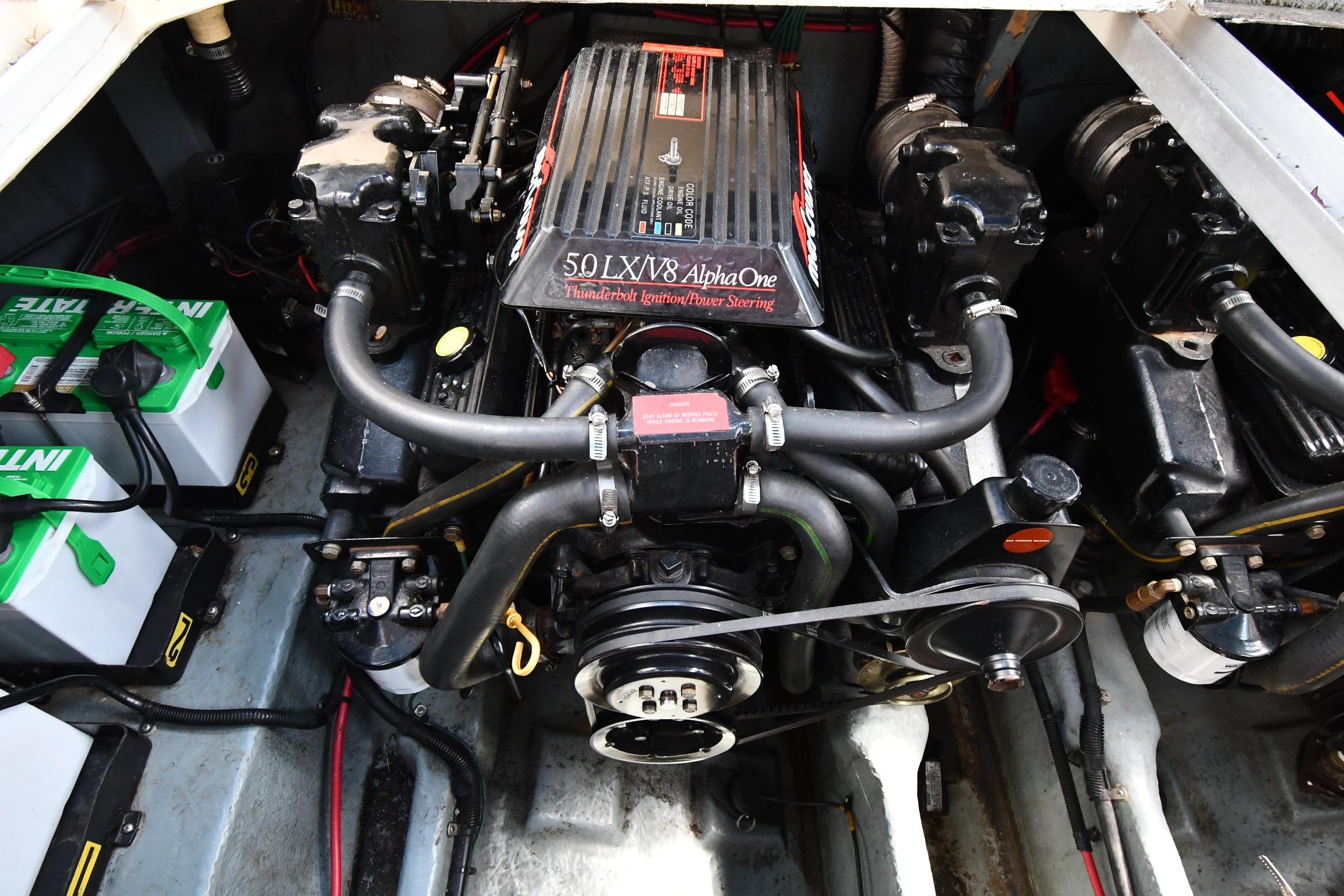 Engine compartment of a 1993 Sea Ray 300 Sundancer with batteries and V8 engine.