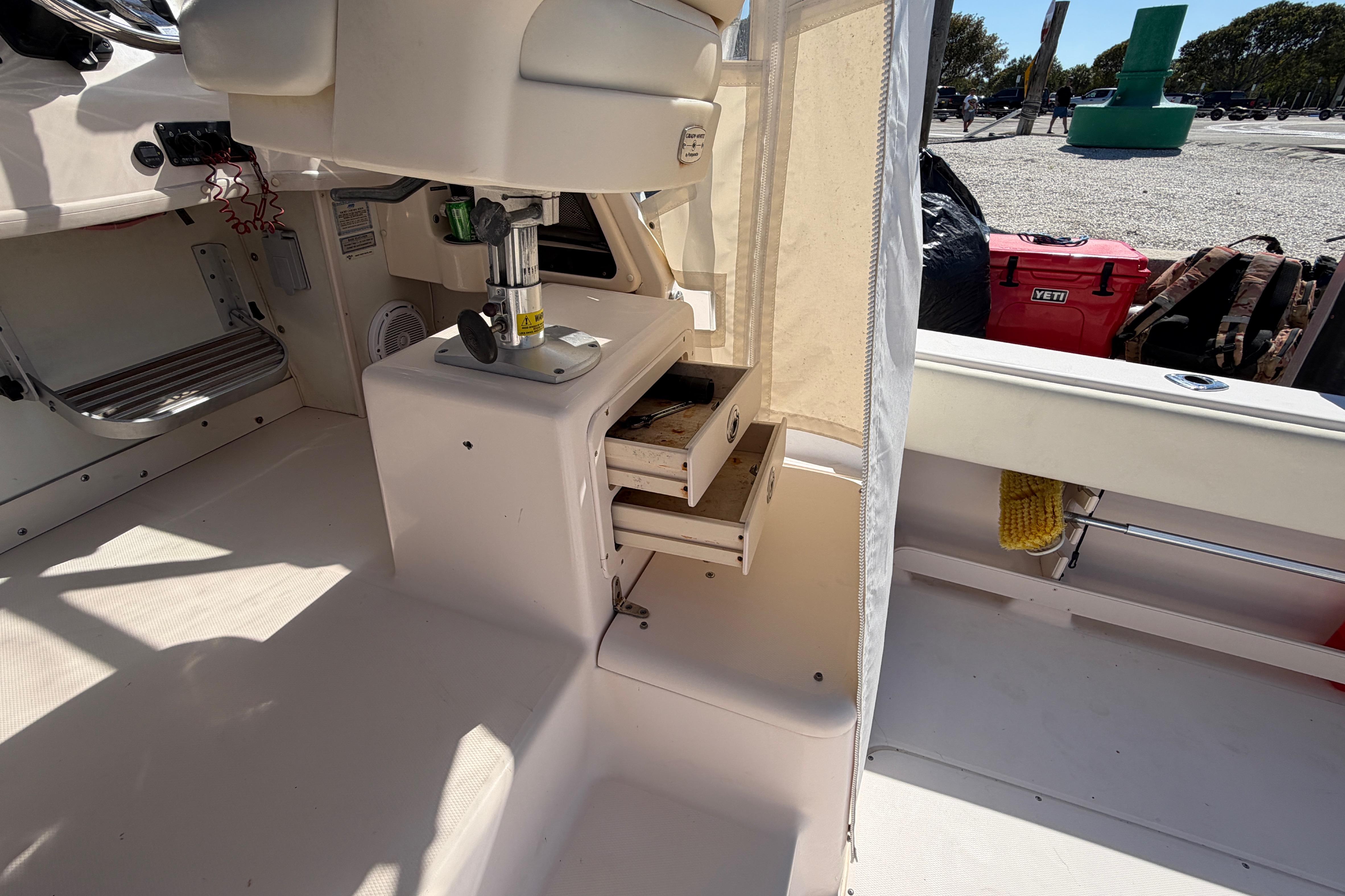 2006 Grady-White Sailfish 282 boat interior with open storage drawers and helm seat.