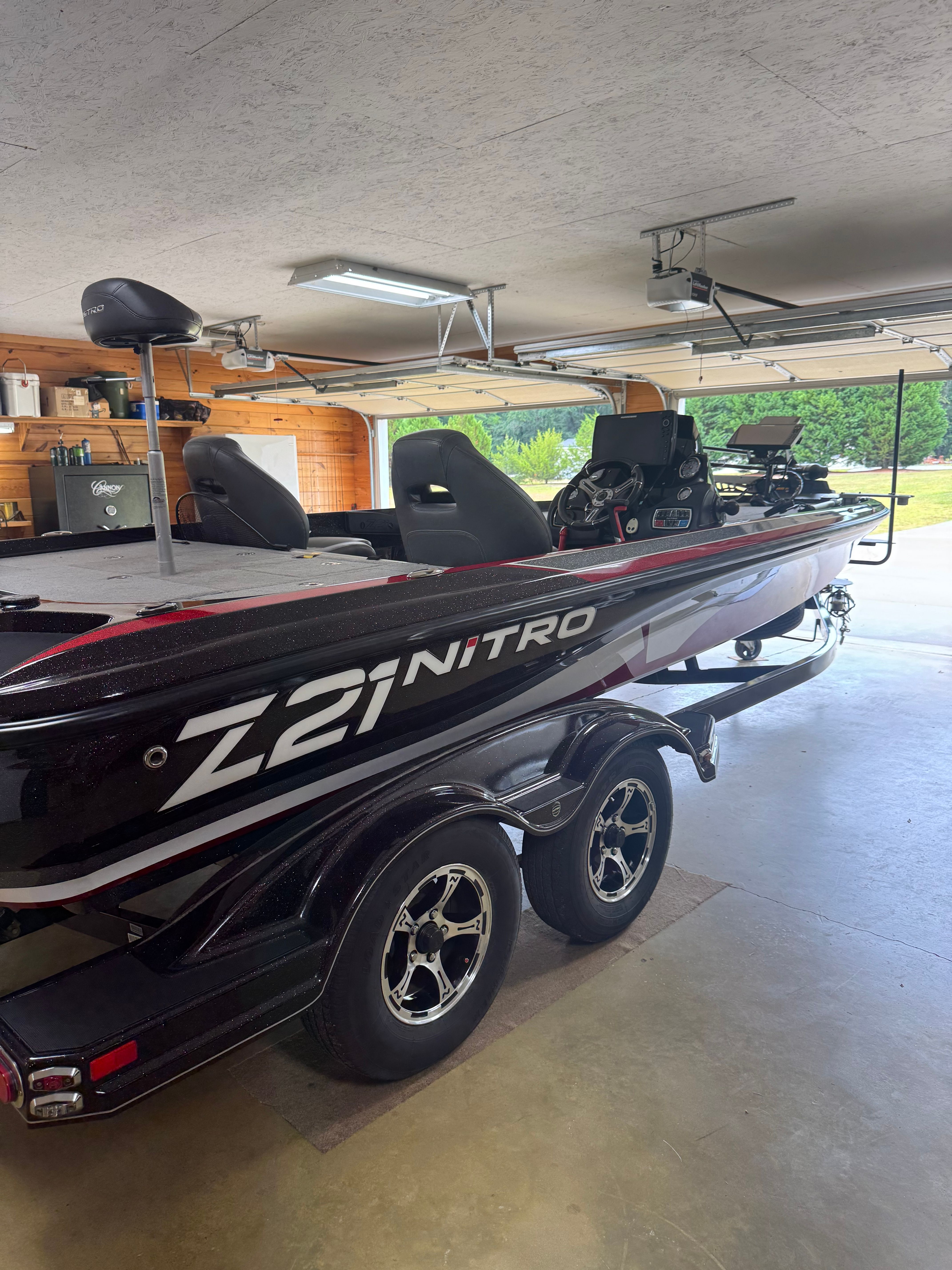 A Nitro Z21 boat is parked in a garage.