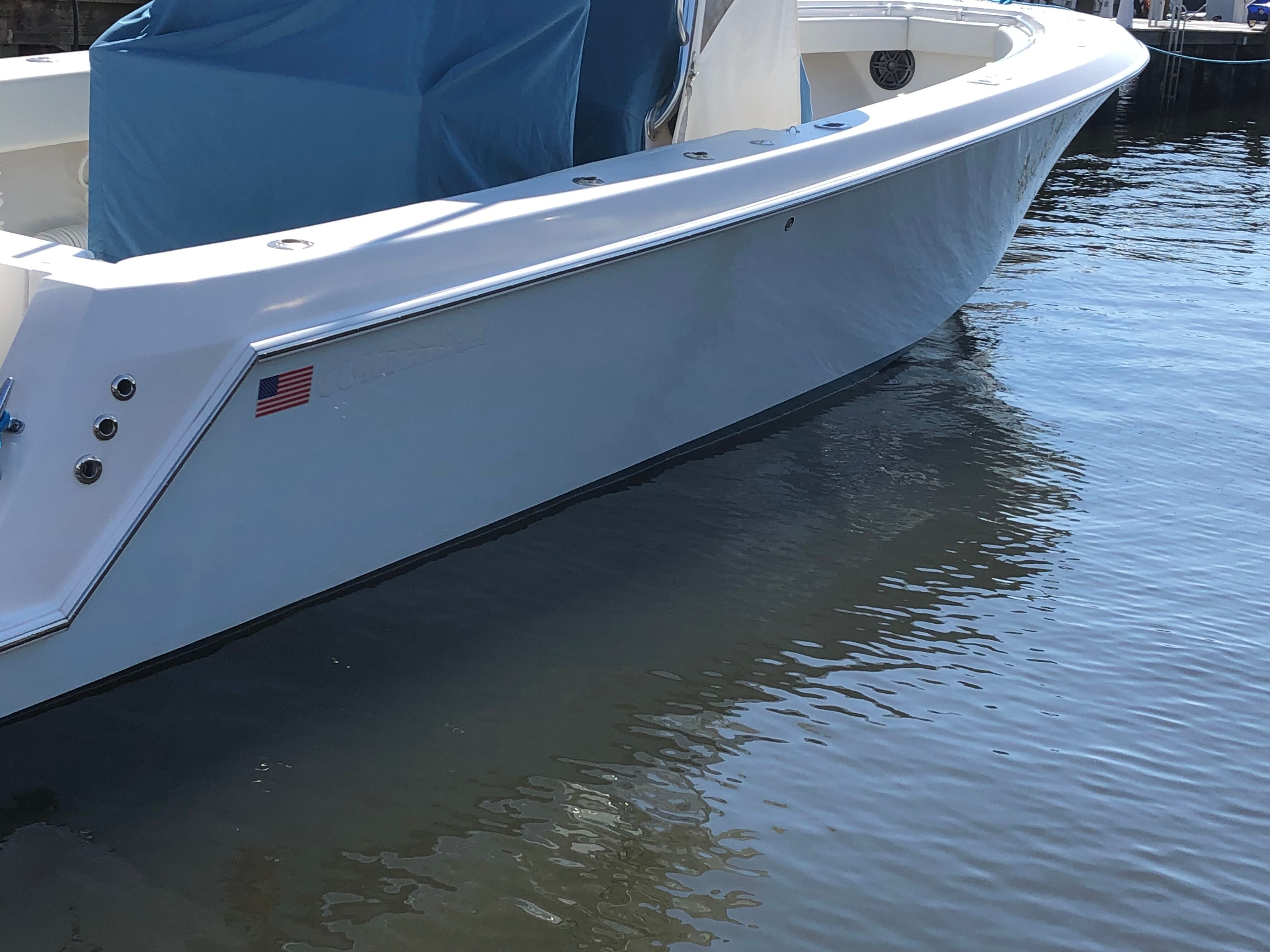 2009 Contender 33 Tournament boat on water, side view.