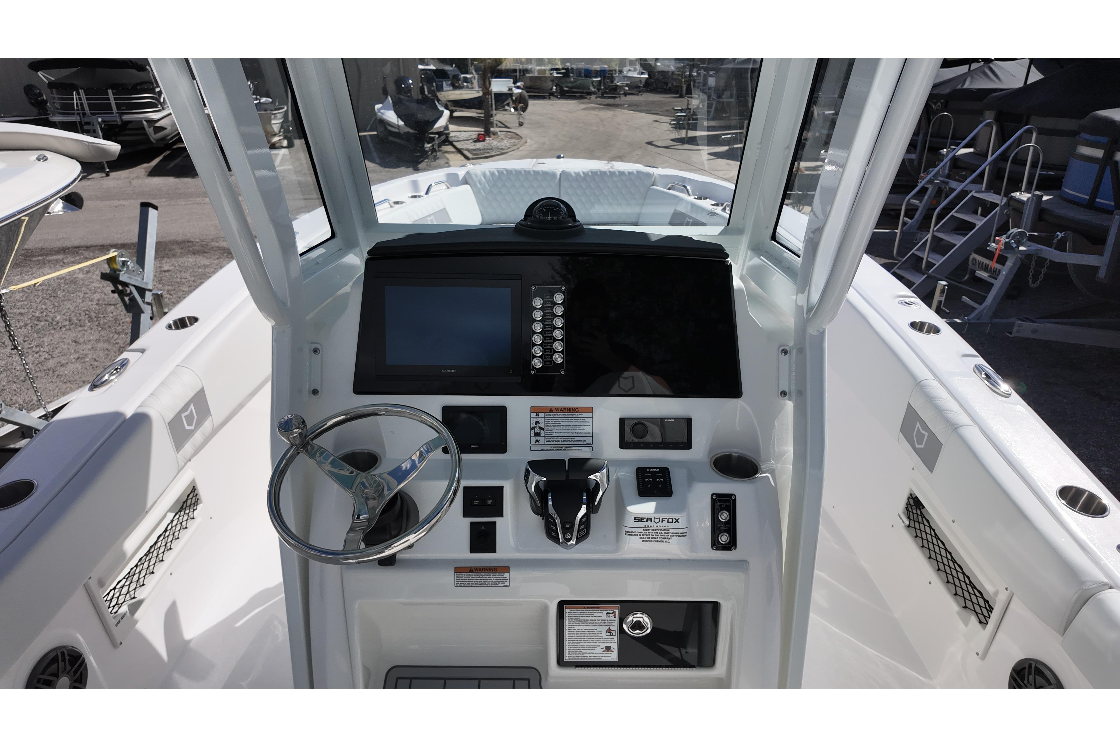 2026 Sea Fox 268 Commander boat cockpit with steering wheel and control panel.
