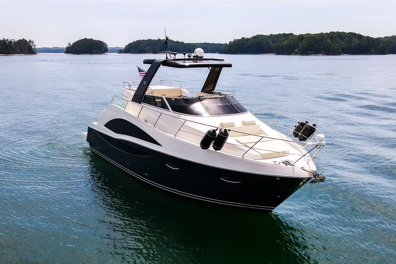 Luxury 2011 Carver 44 Sojourn yacht cruising on serene waters.