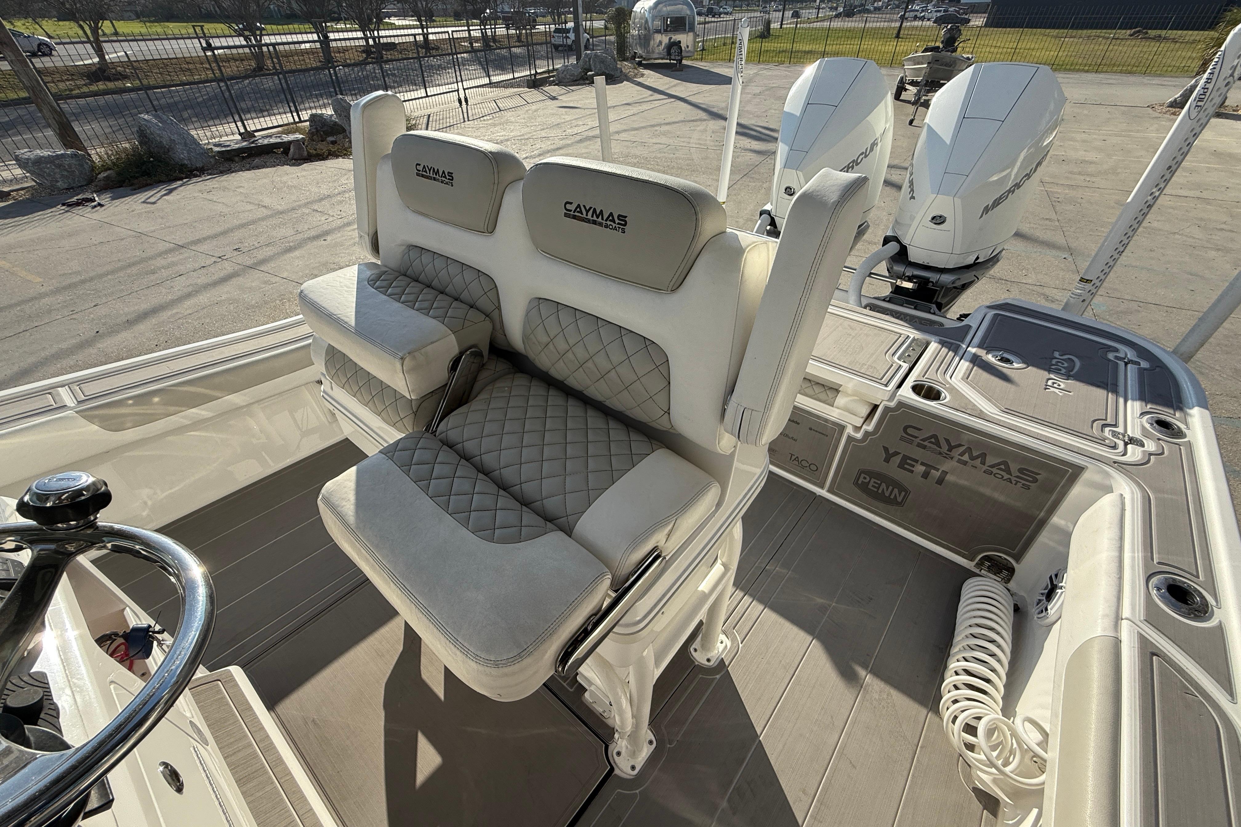 2022 Caymas 28 HB Twin boat interior with cushioned seating and dual engines.