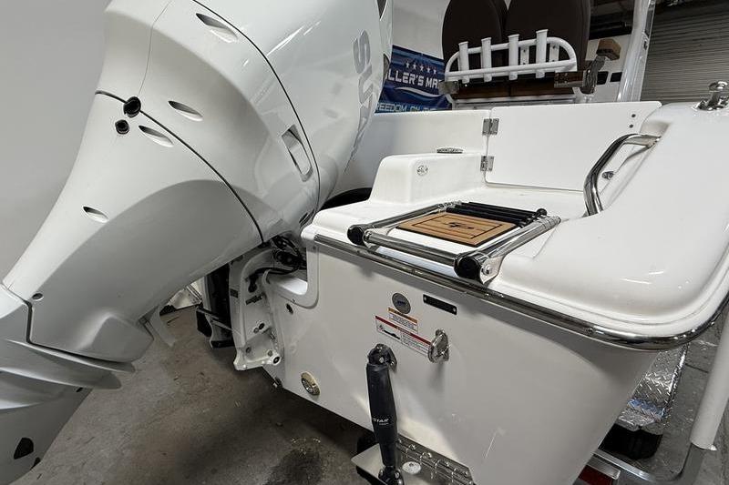 2026 Sea Pro 242 Center Console boat with powerful outboard motor and swim platform.