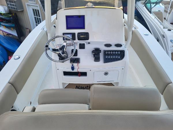 2021 NauticStar 2302 Legacy boat console with steering wheel and navigation equipment.