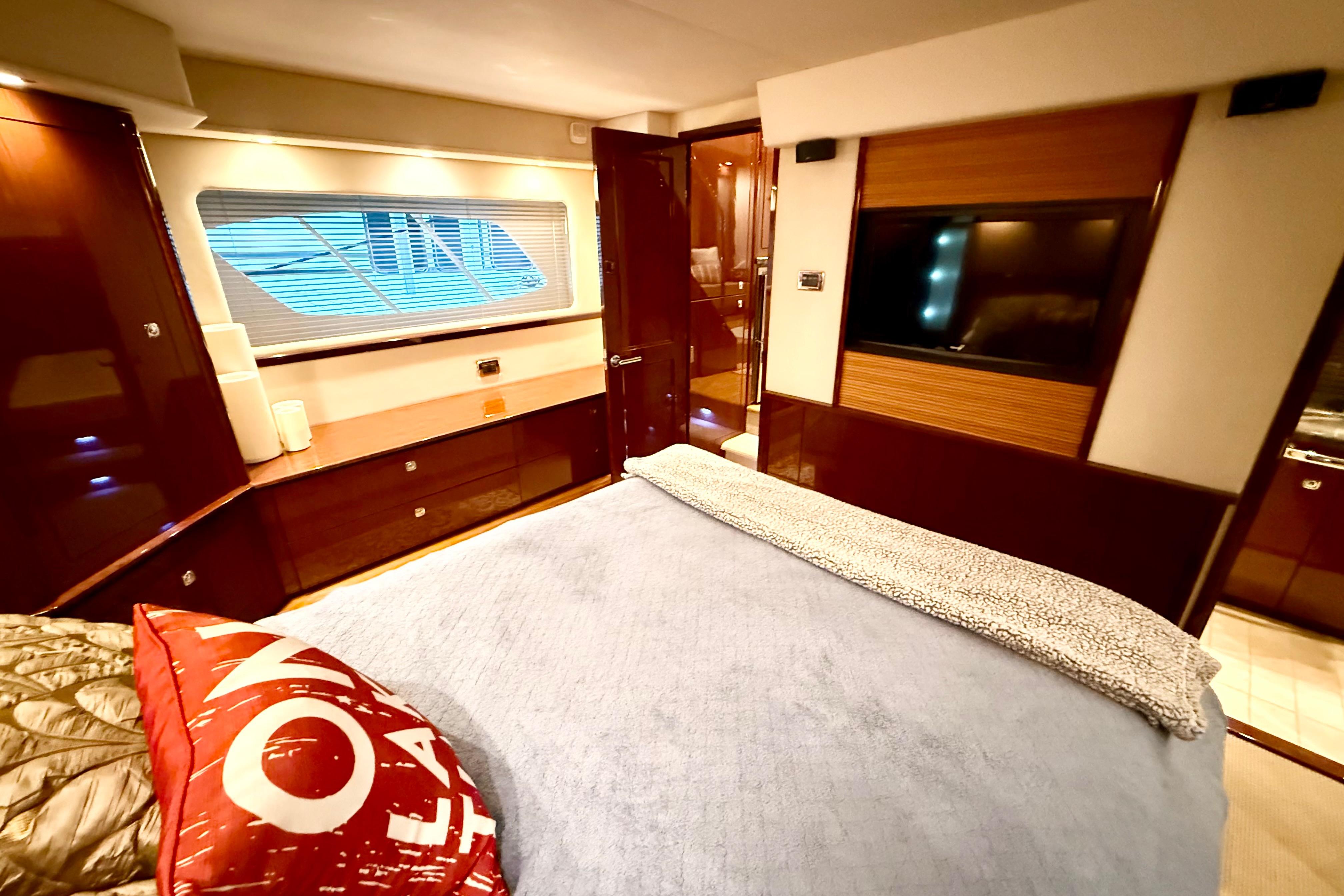 Luxurious 2014 Sea Ray 580 Sundancer yacht bedroom with elegant wood finishes.