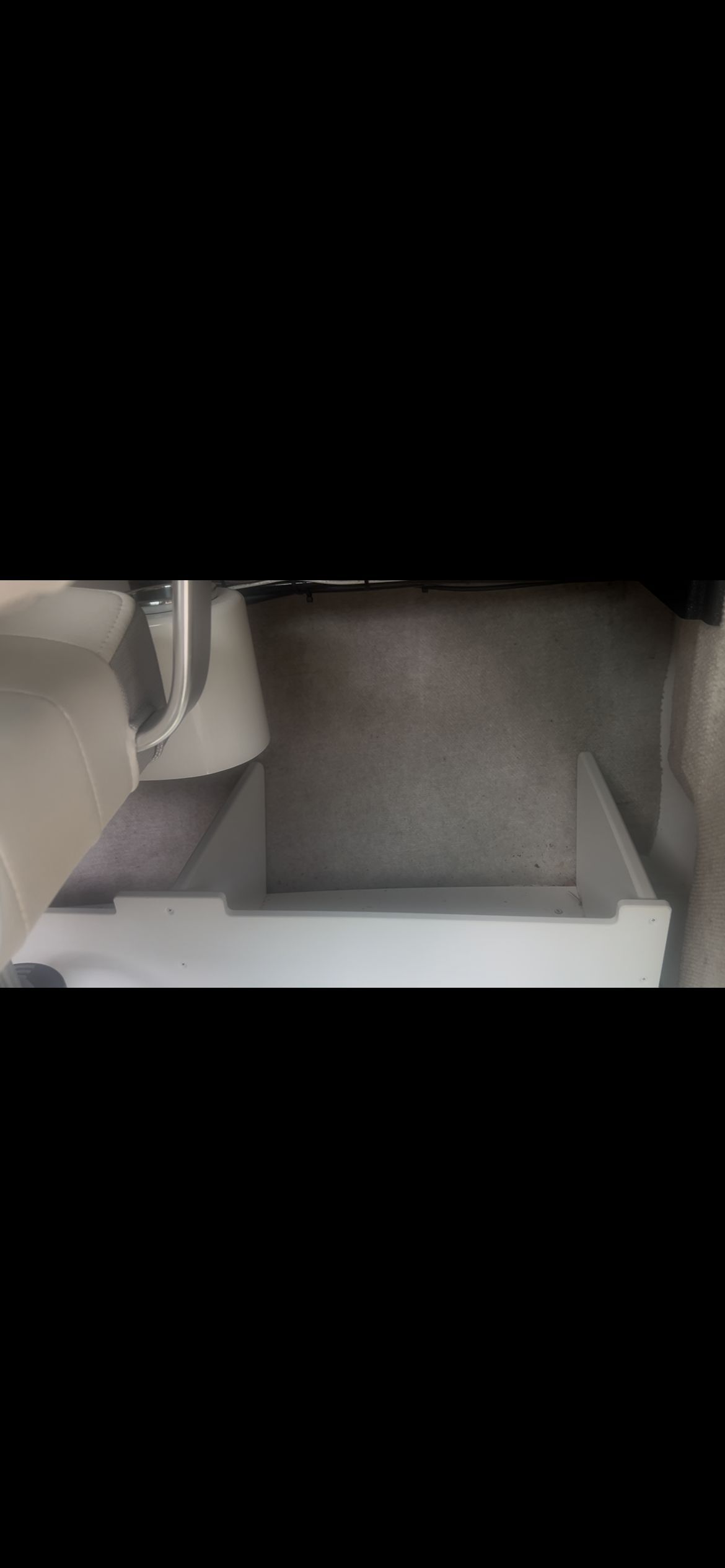 Interior of a Parker 2320 Sport Cabin boat with seating and storage area.