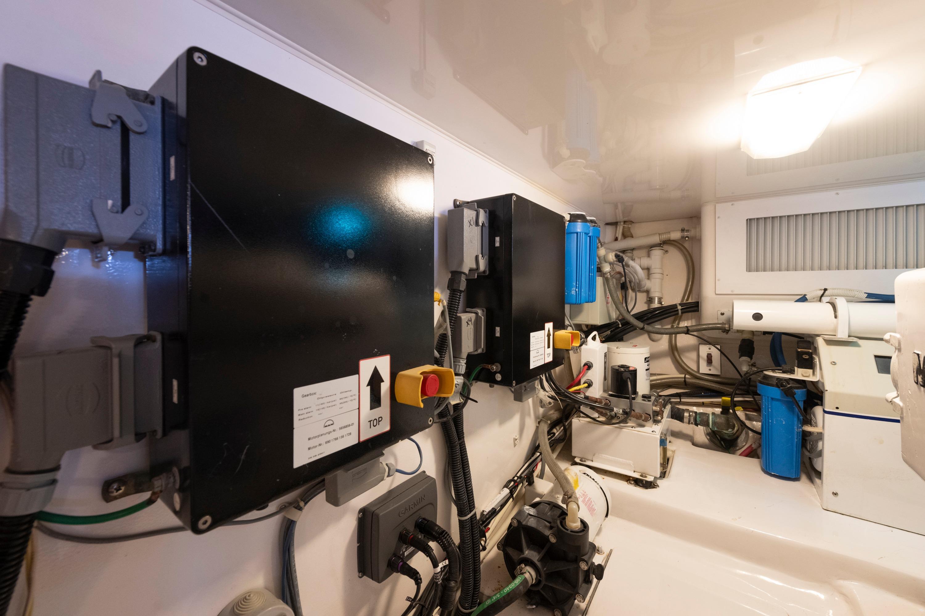 Engine room of 2009 Viking 50 Convertible yacht, showcasing electrical panels and machinery.