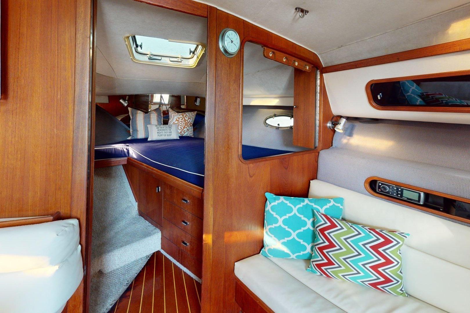Interior of a 1989 Tiara 3300 Open yacht with cozy seating and vibrant cushions.