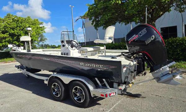 2024 Ranger RB200 boat with trailer and outboard motor in sunny outdoor setting.