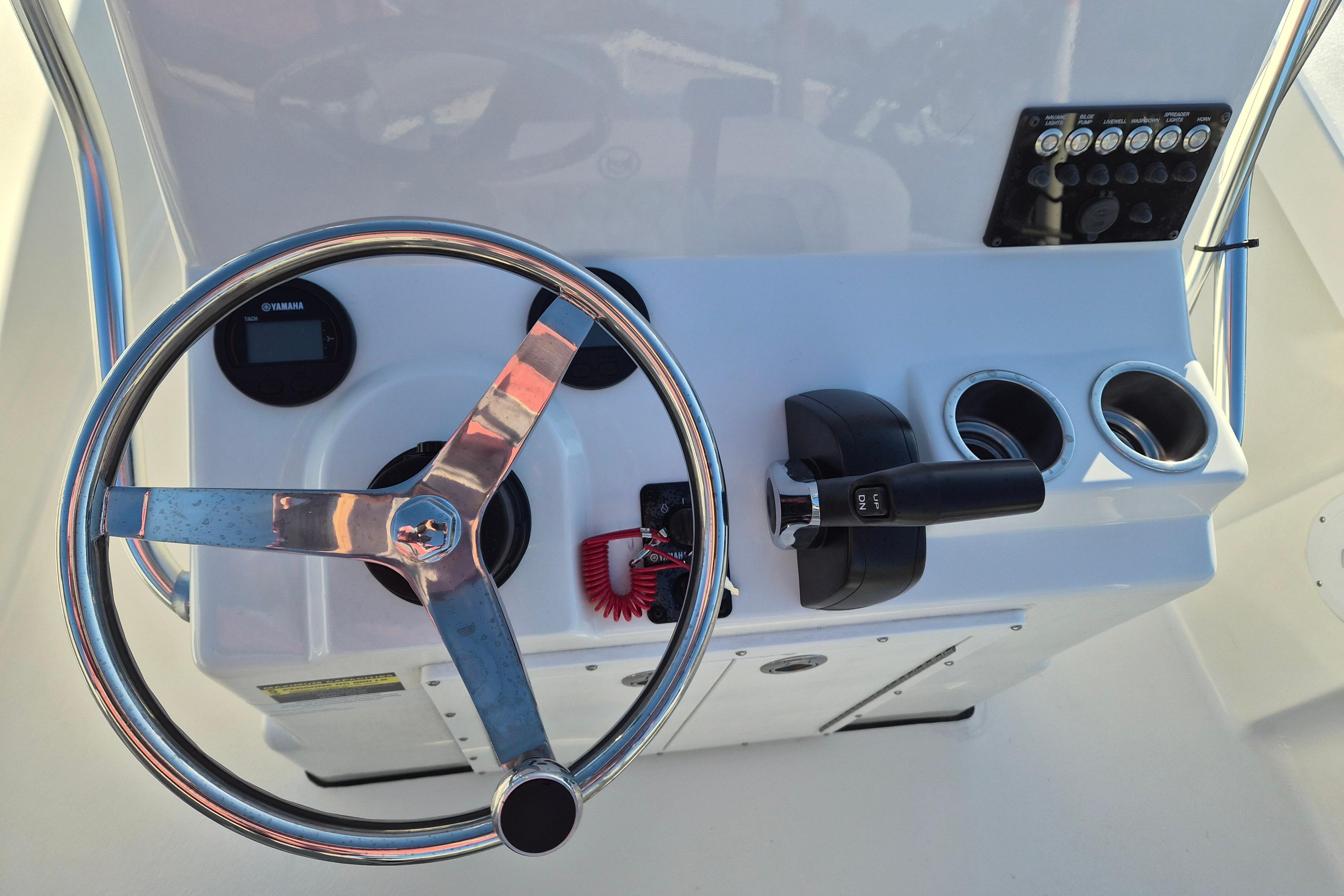 Steering console of 2026 May-Craft 192 boat with controls and gauges.