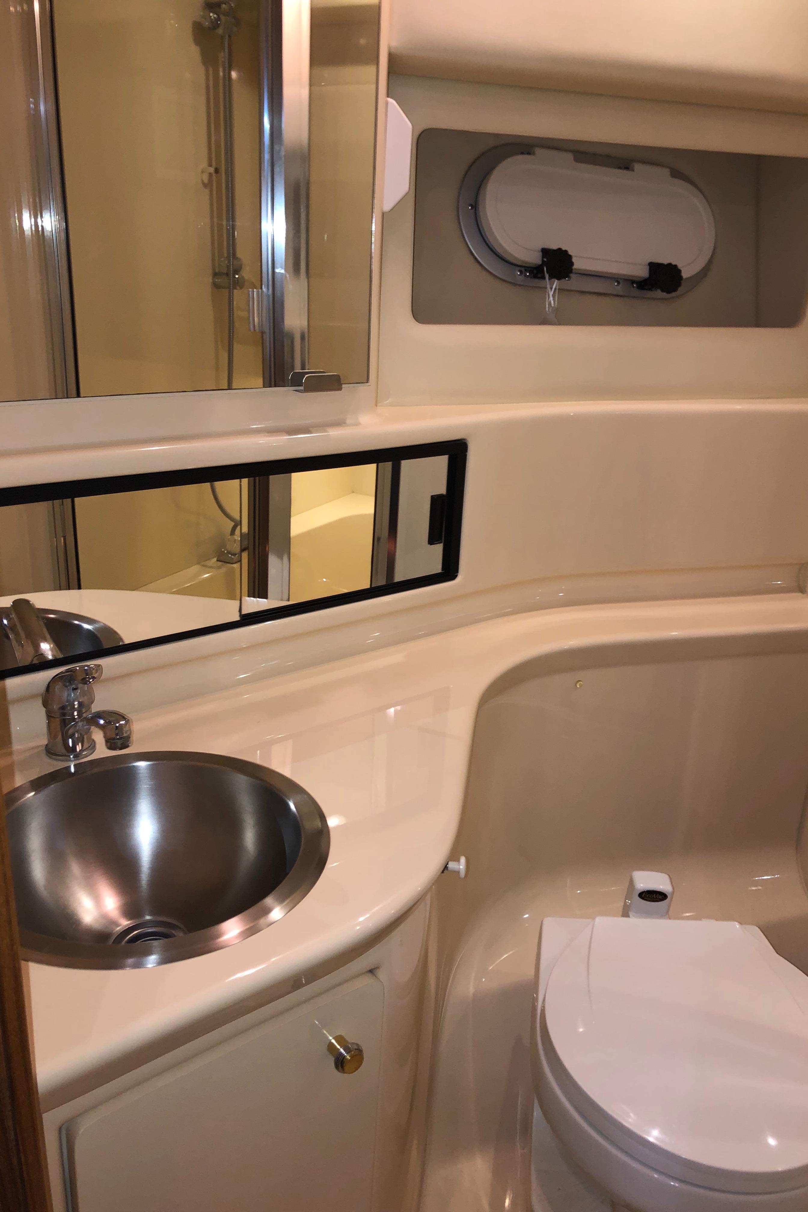 2002 Bayliner 39 Motor Yacht bathroom with sink, toilet, and shower.