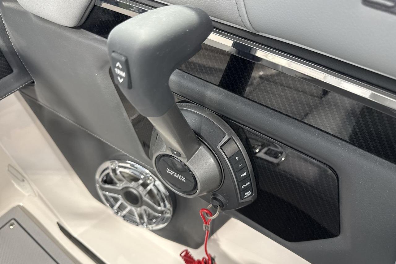 Close-up of a boat throttle lever with a red safety lanyard.