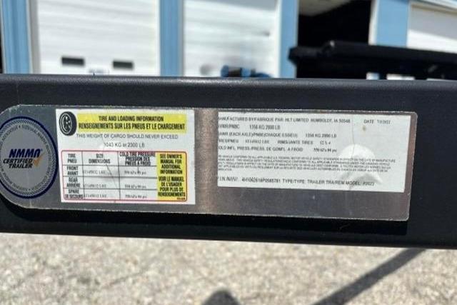 Label on 2023 Yacht Club 18' Pontoon trailer displaying tire and loading information.
