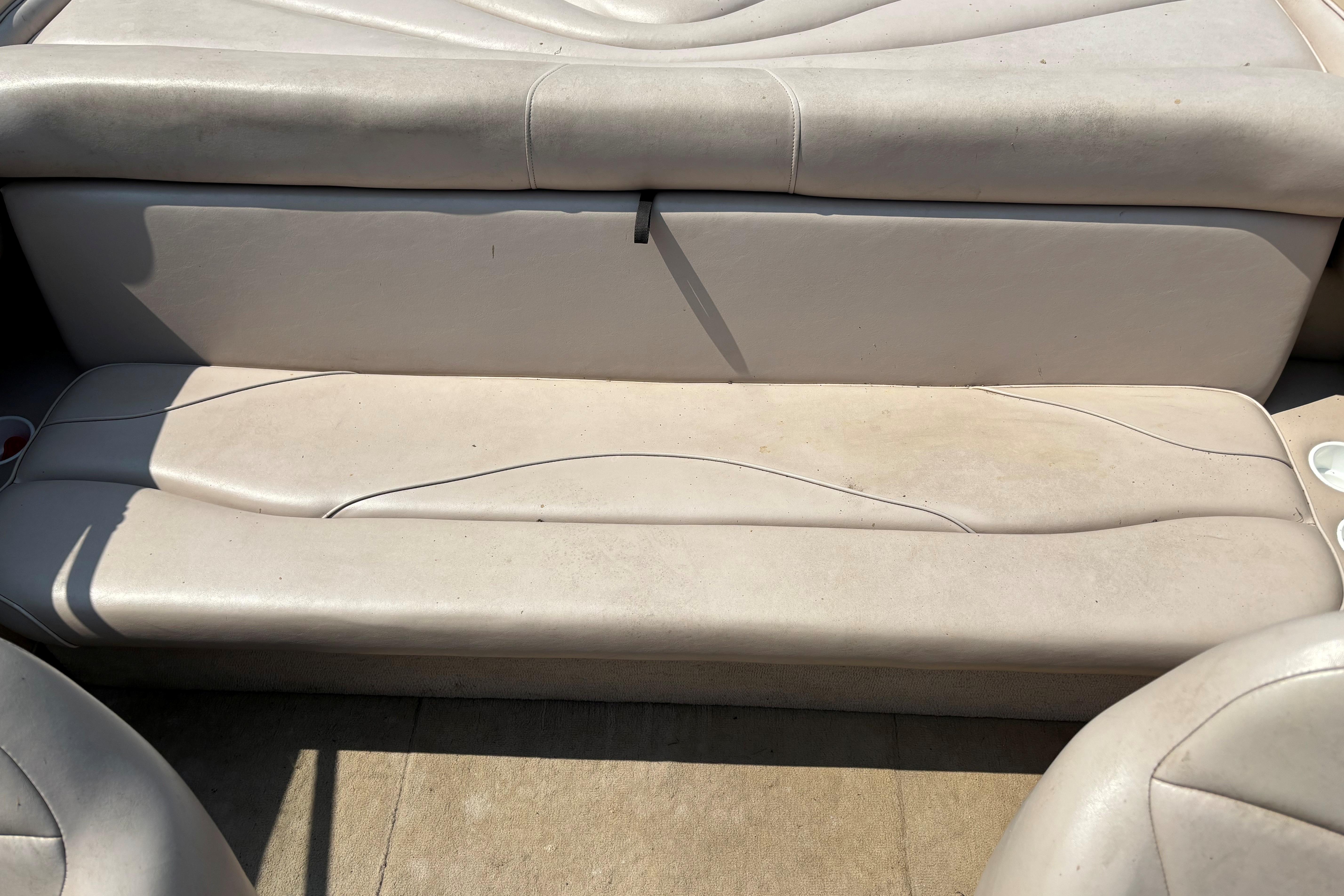 2001 Crownline 18' boat interior seating with light beige upholstery.