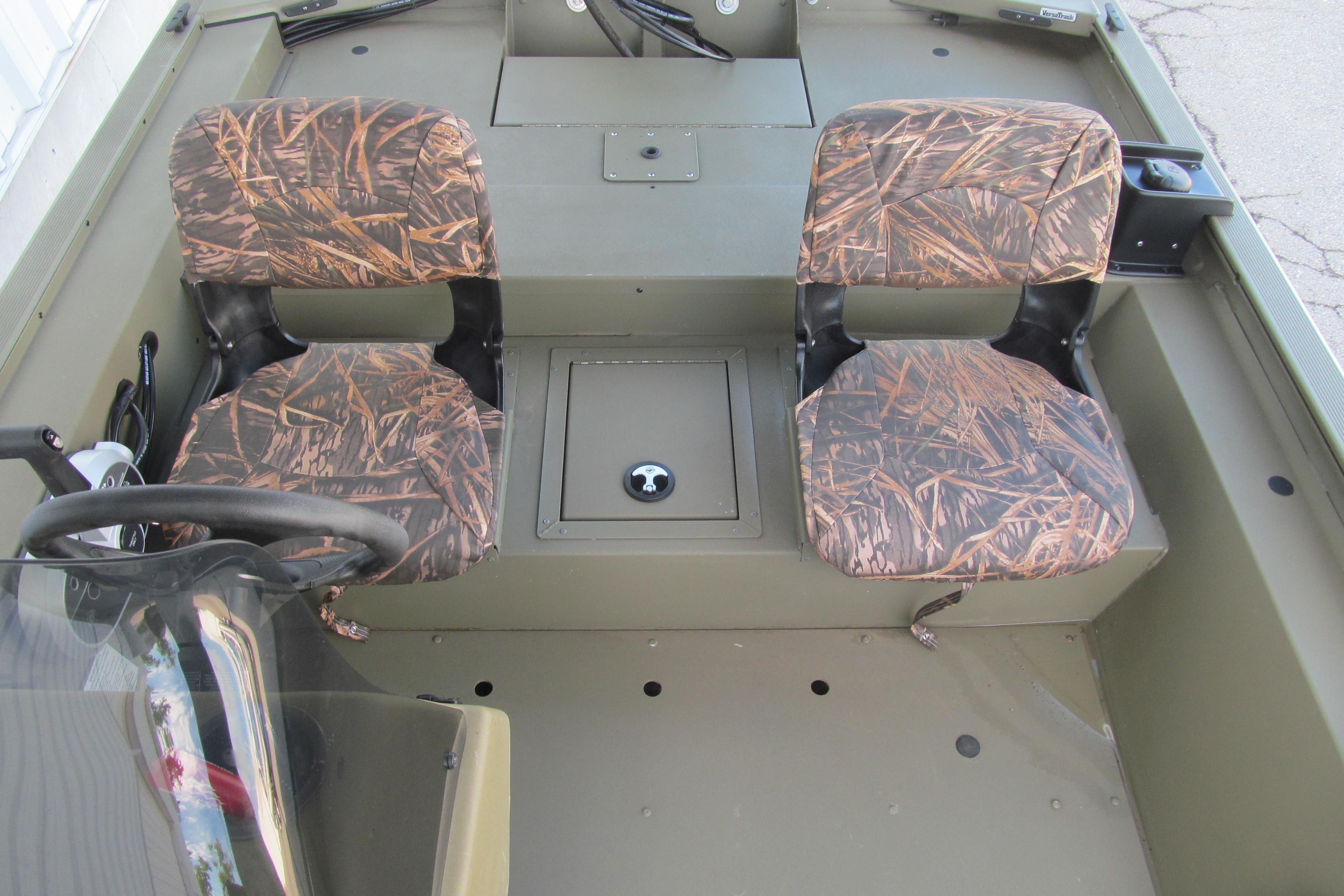 2018 Tracker Grizzly 1754 SC boat interior with camo seats and steering console.
