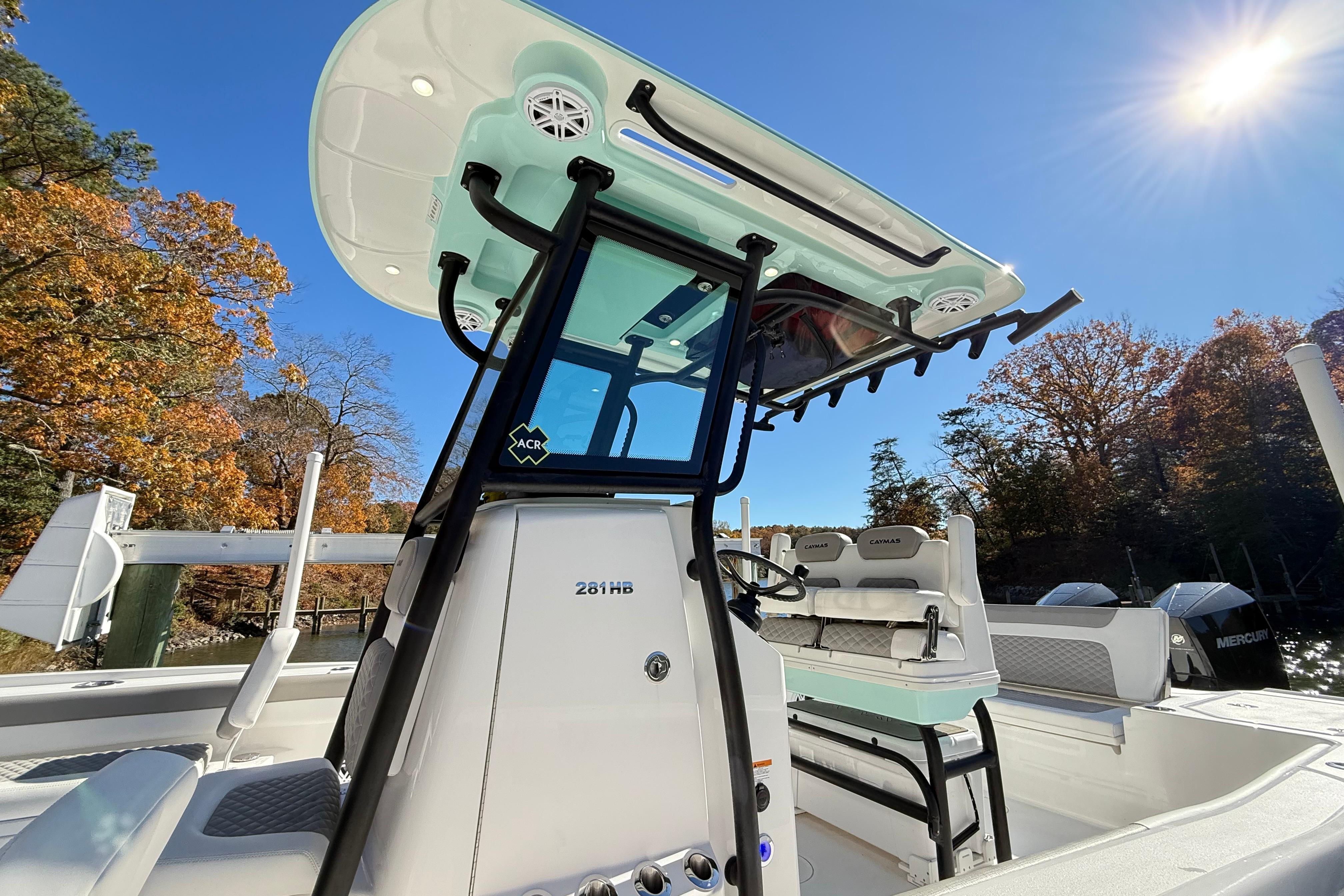 2023 Caymas 281 HB boat with sleek design, set against a sunny autumn backdrop.