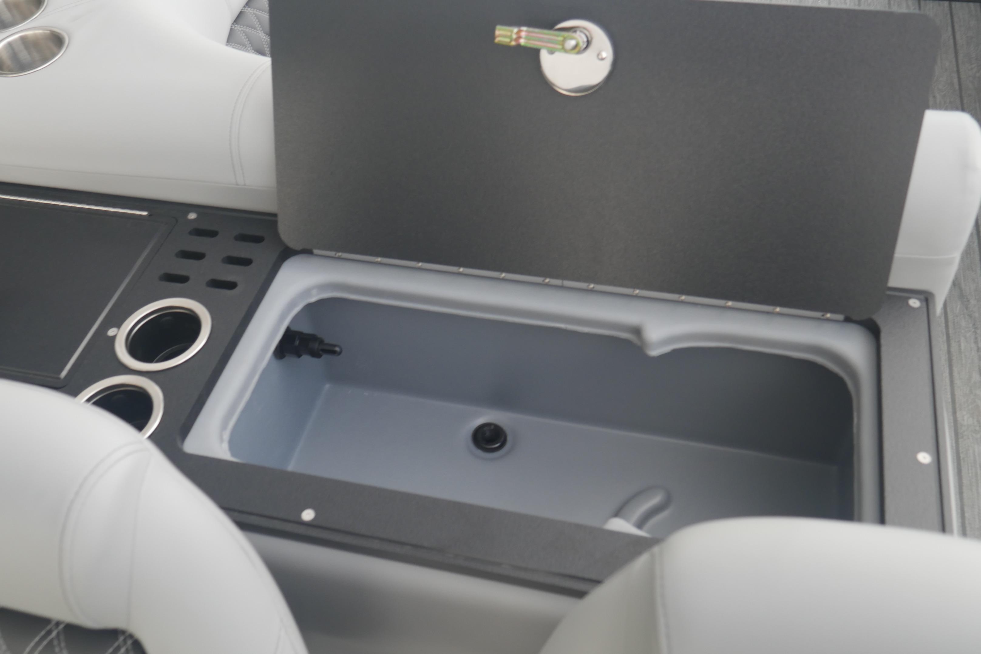 Open storage compartment in 2026 Ranger 220FC boat with cup holders and sleek design.