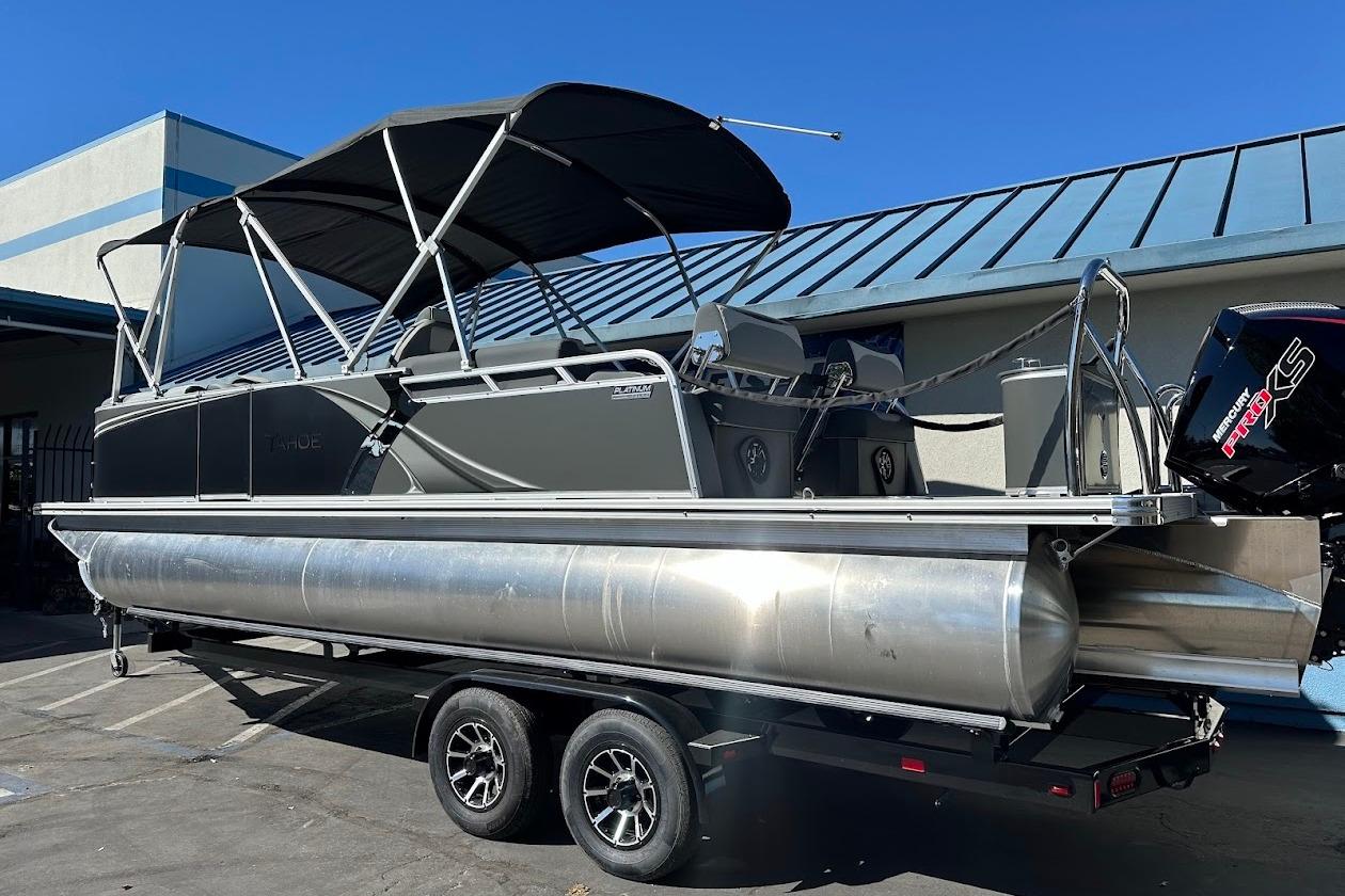 2026 Tahoe Pontoon LTZ Quad Lounger Shift 23 on trailer, featuring sleek design and canopy.