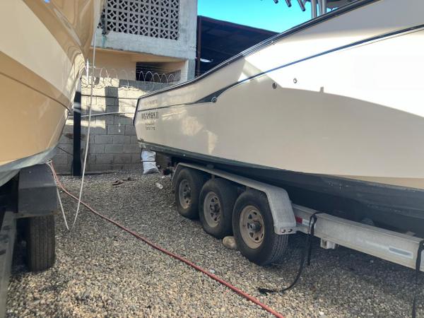 2006 Grady-White Bimini 306 boat on a trailer in a gravel yard.