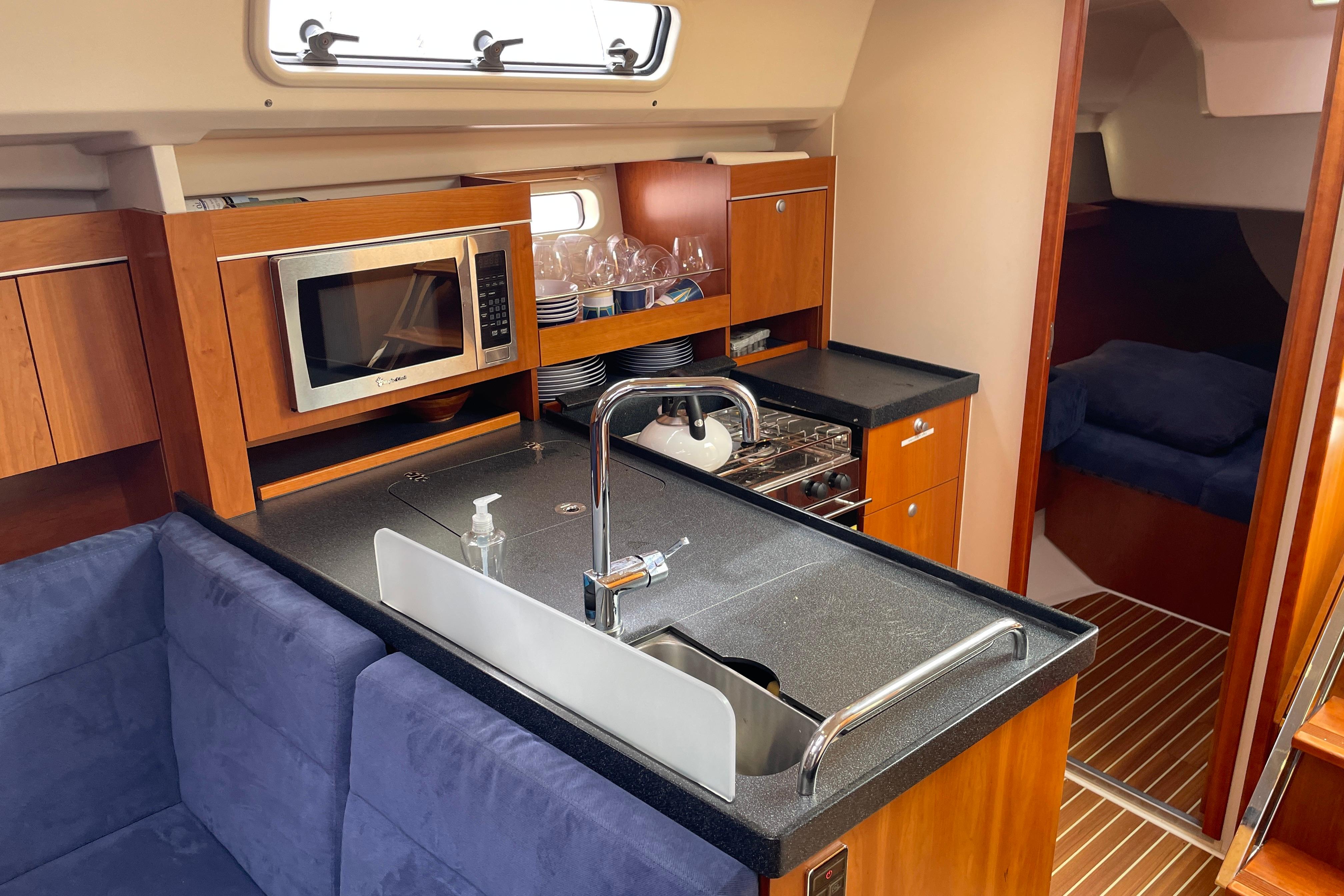 2014 Hanse 415 yacht interior with modern kitchen, featuring microwave and sink.