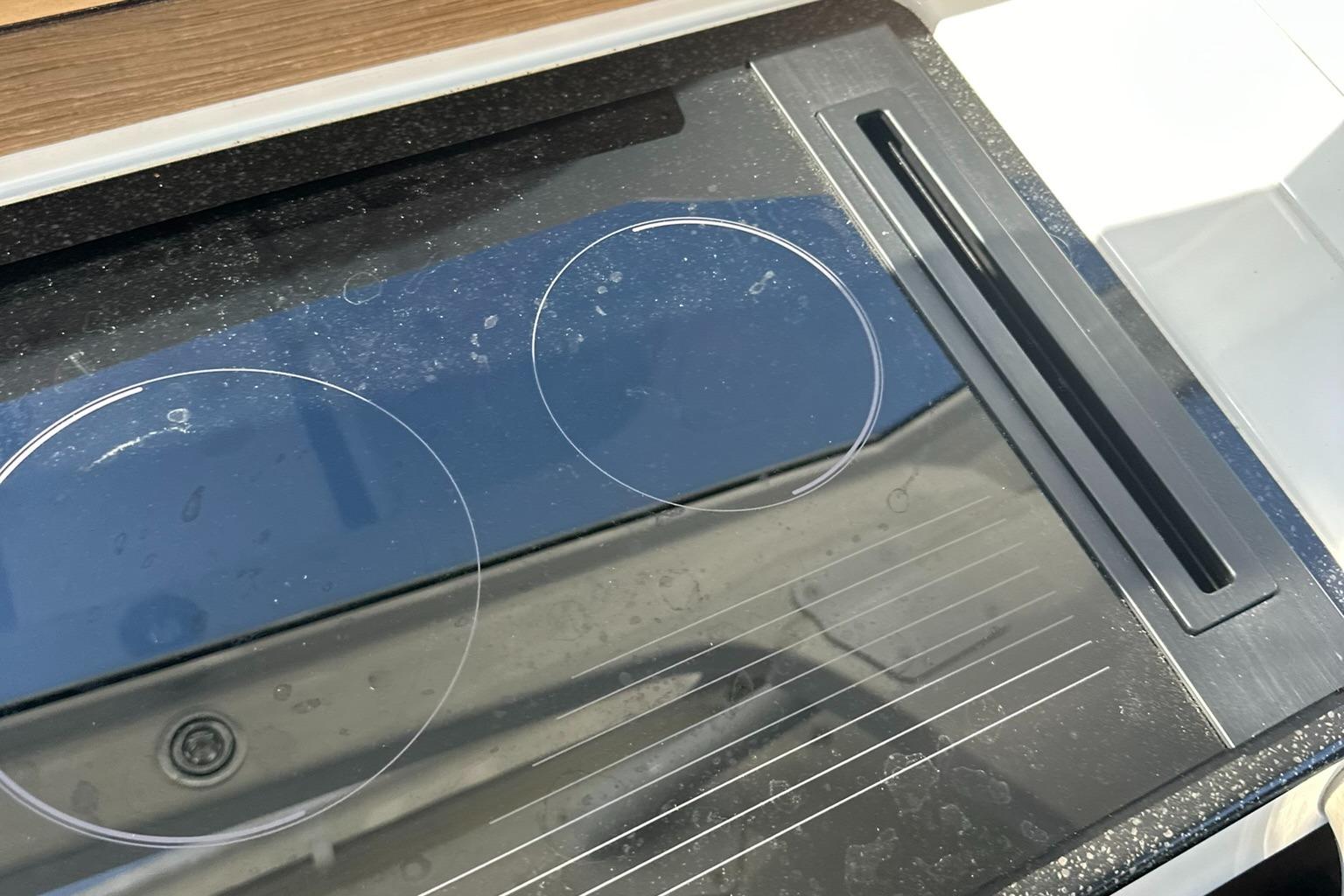Modern glass cooktop on 2021 Nimbus W9 boat kitchen.