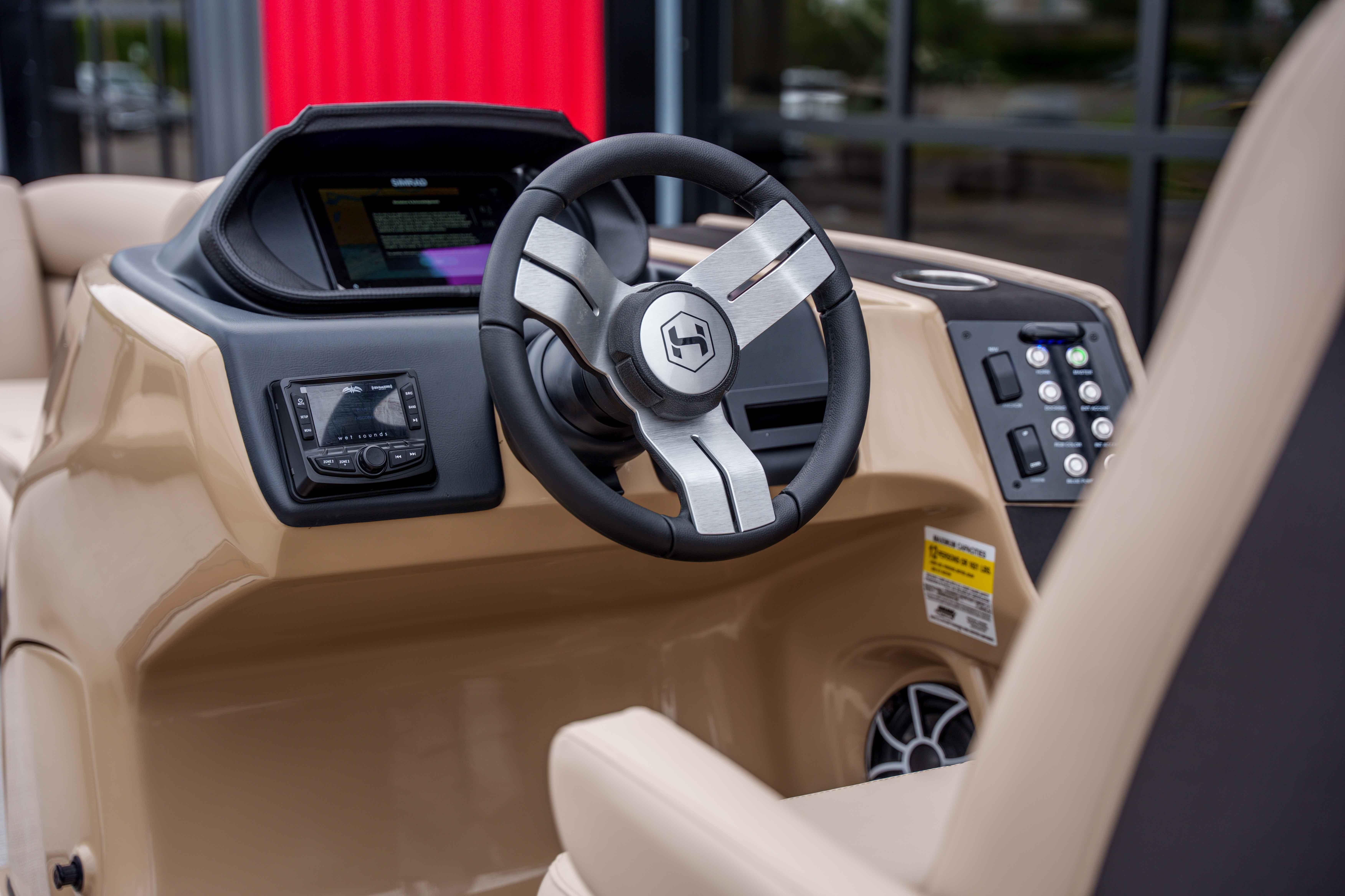 2026 Harris Sunliner 230 boat dashboard with modern steering wheel and control panel.