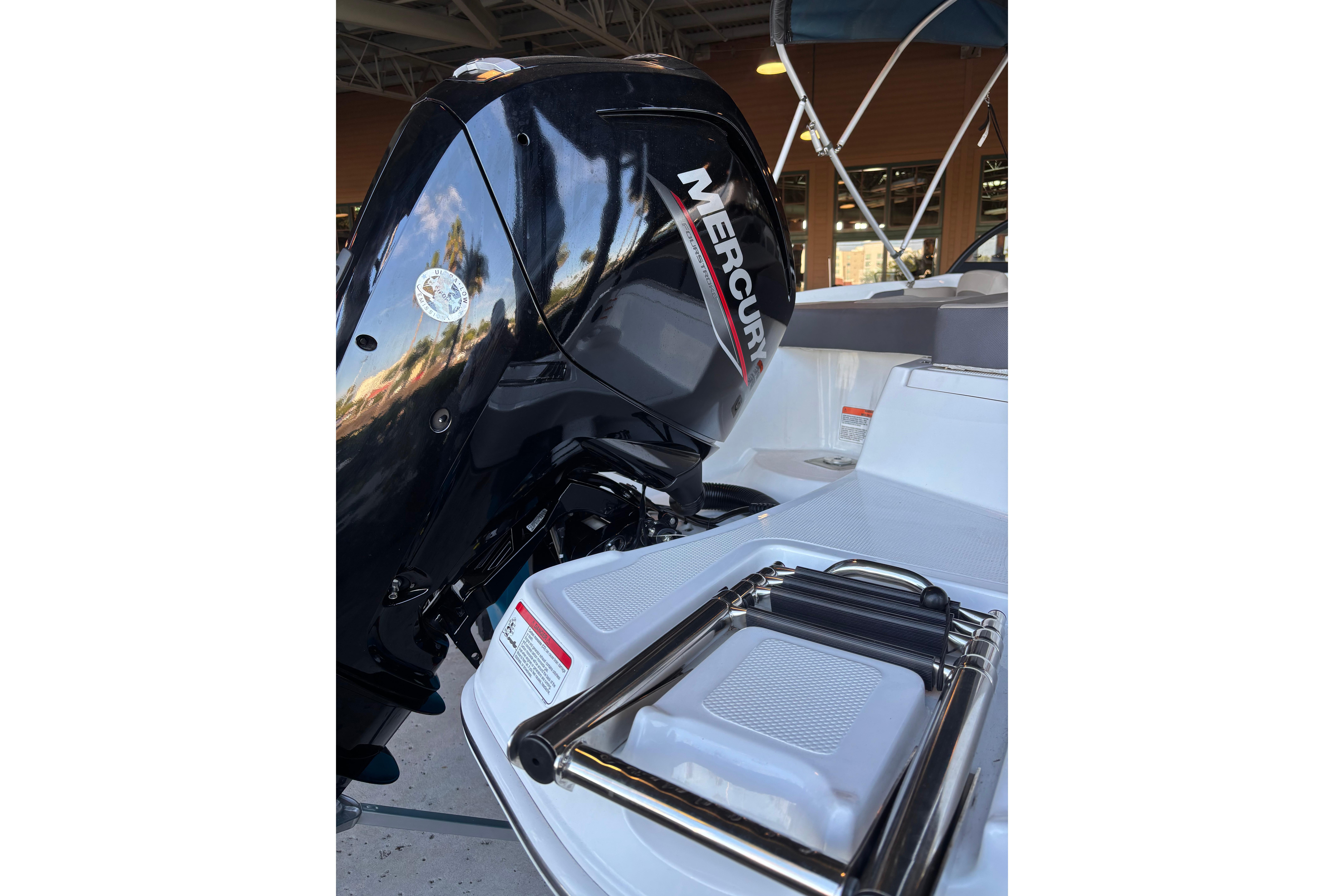 2025 Tahoe 200 S boat with Mercury engine and foldable ladder.