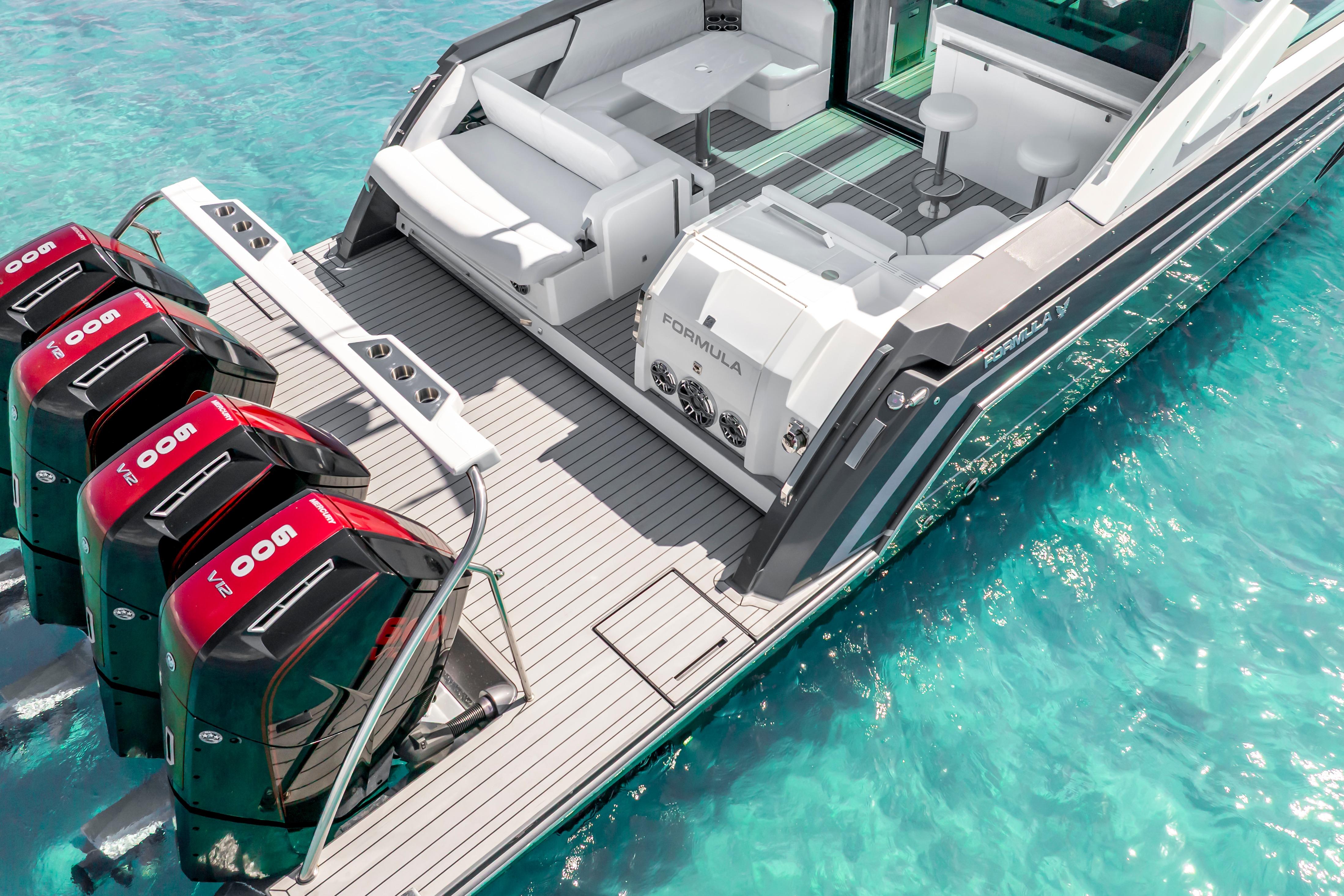 2022 Formula 500 Super Sport Crossover boat with powerful engines on clear turquoise water.