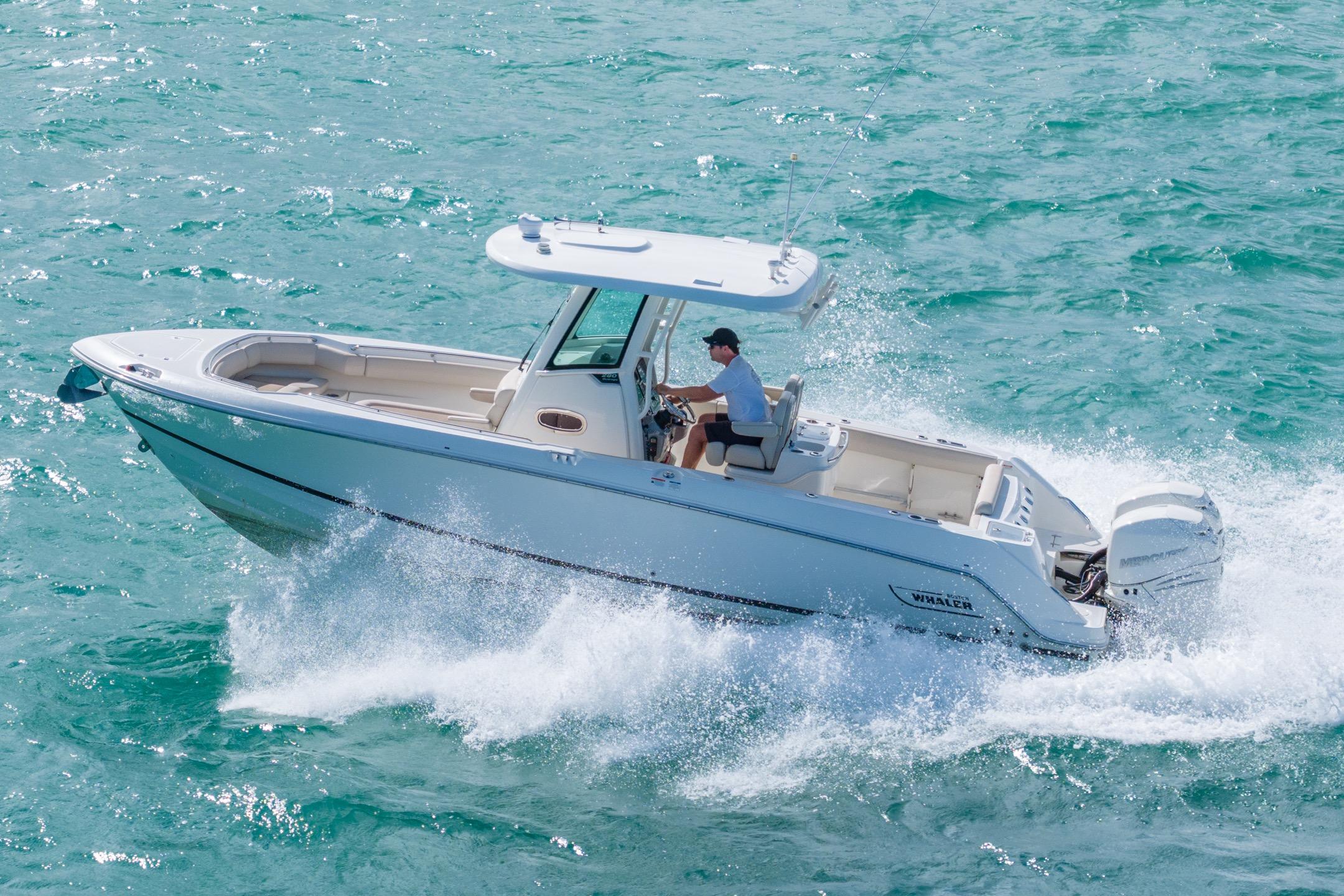 2016 Boston Whaler 280 Outrage cruising on turquoise ocean waters.