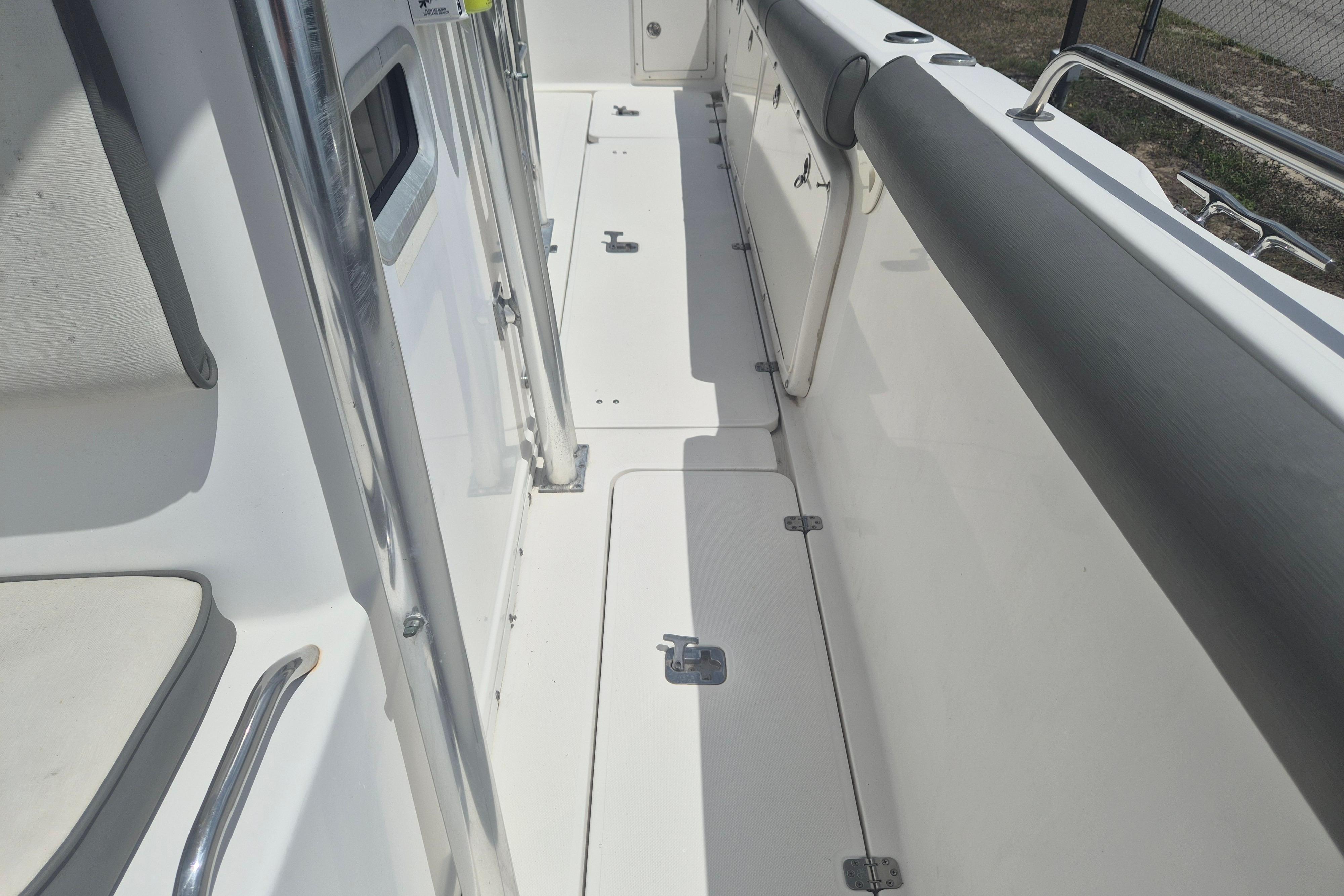 2006 Century 2900 Center Console boat interior with white deck and stainless steel railings.