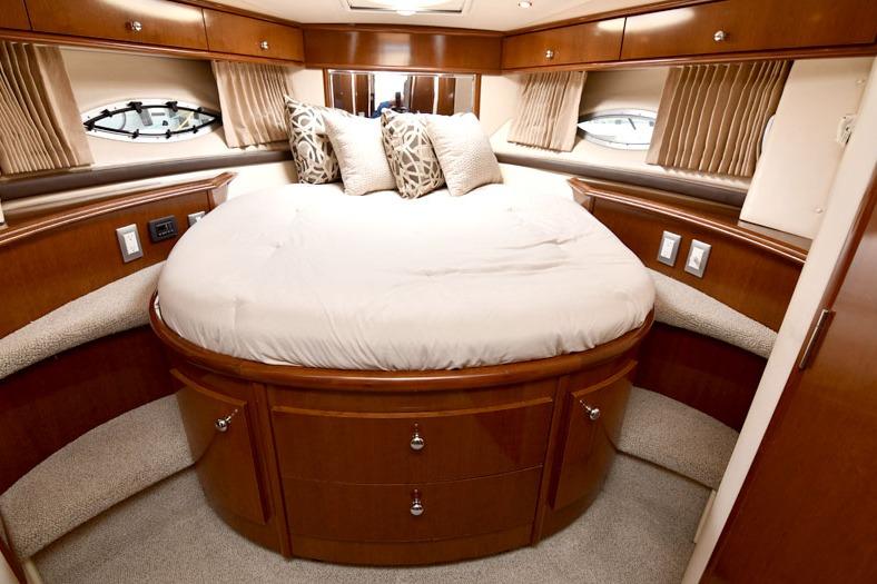 Luxurious cabin interior of 2008 Carver 43 Super Sport yacht with round bed.
