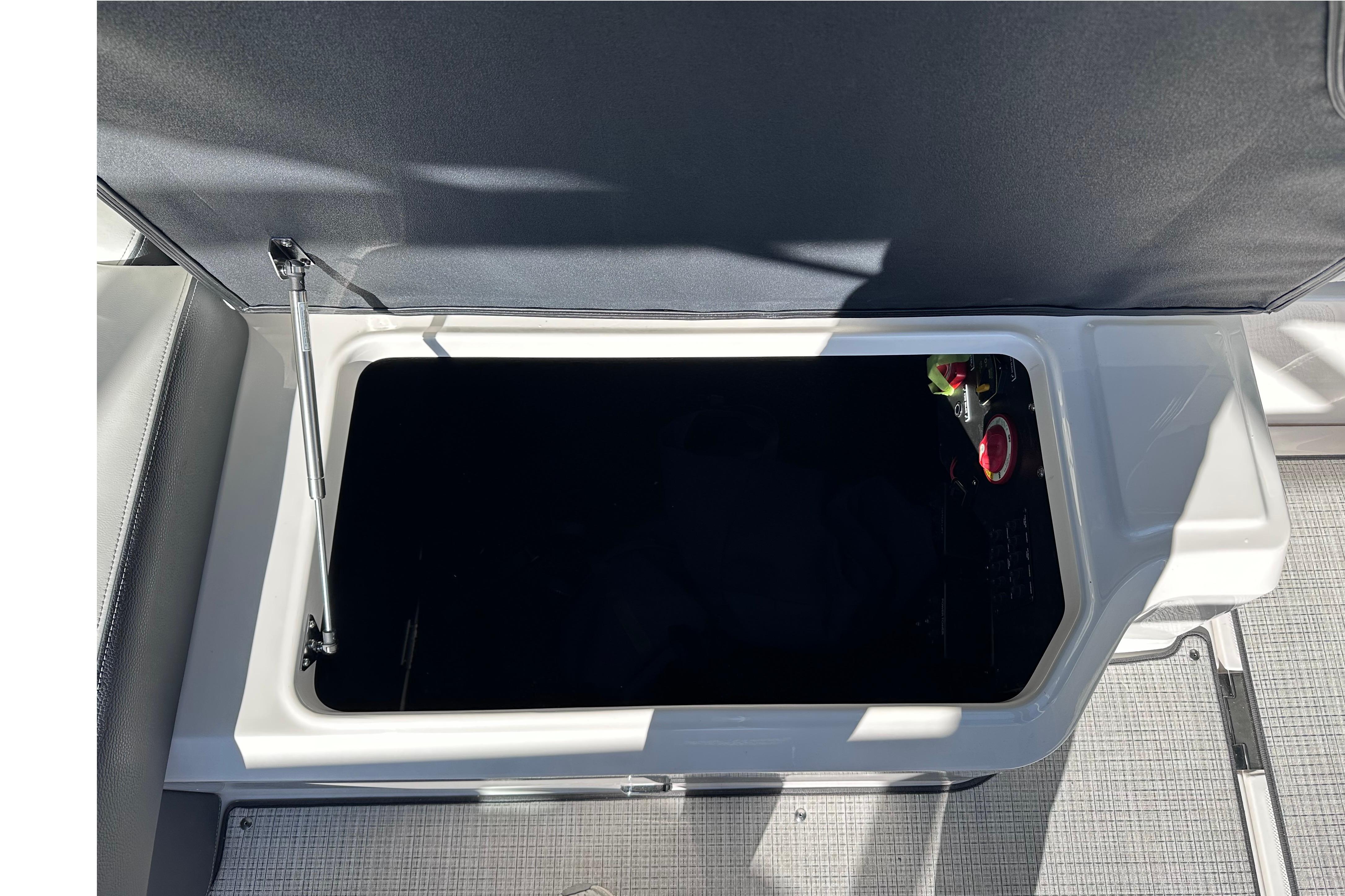Open storage compartment in 2026 Regal LX4 boat, showcasing interior details.