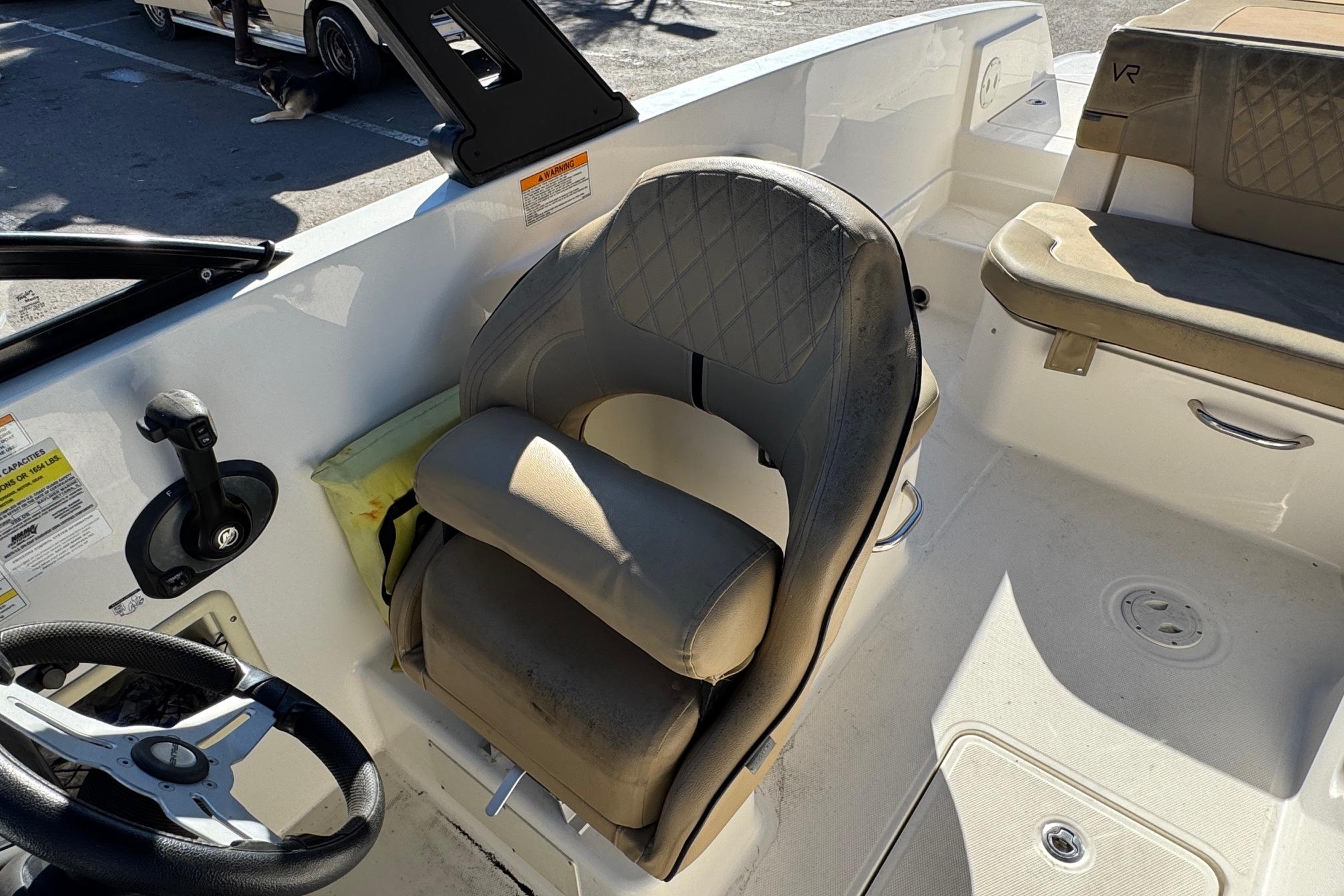 2022 Bayliner VR6 Bowrider OB interior with steering wheel and cushioned seating.