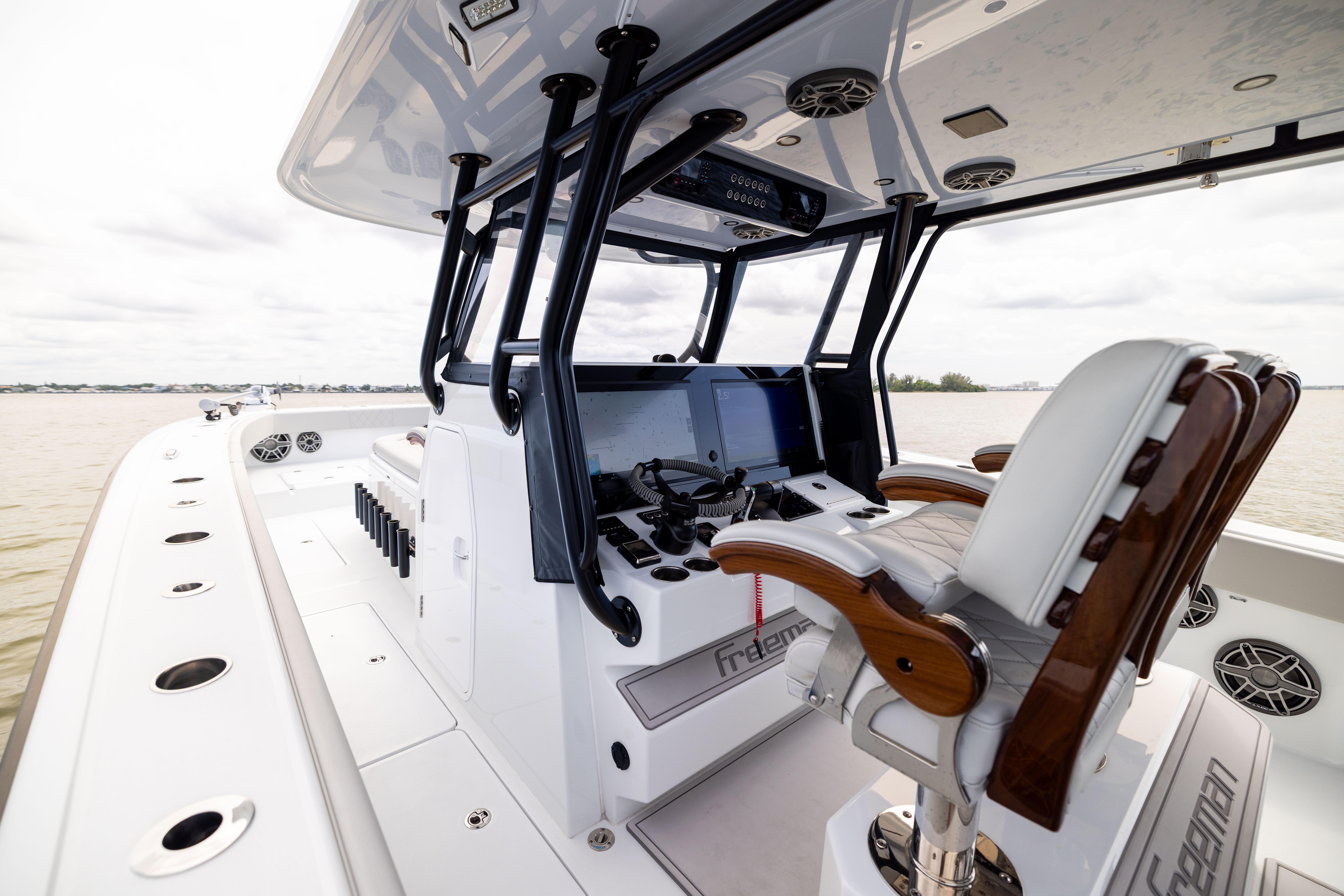 2025 Freeman 42 LR boat cockpit with modern controls and luxurious seating on open water.