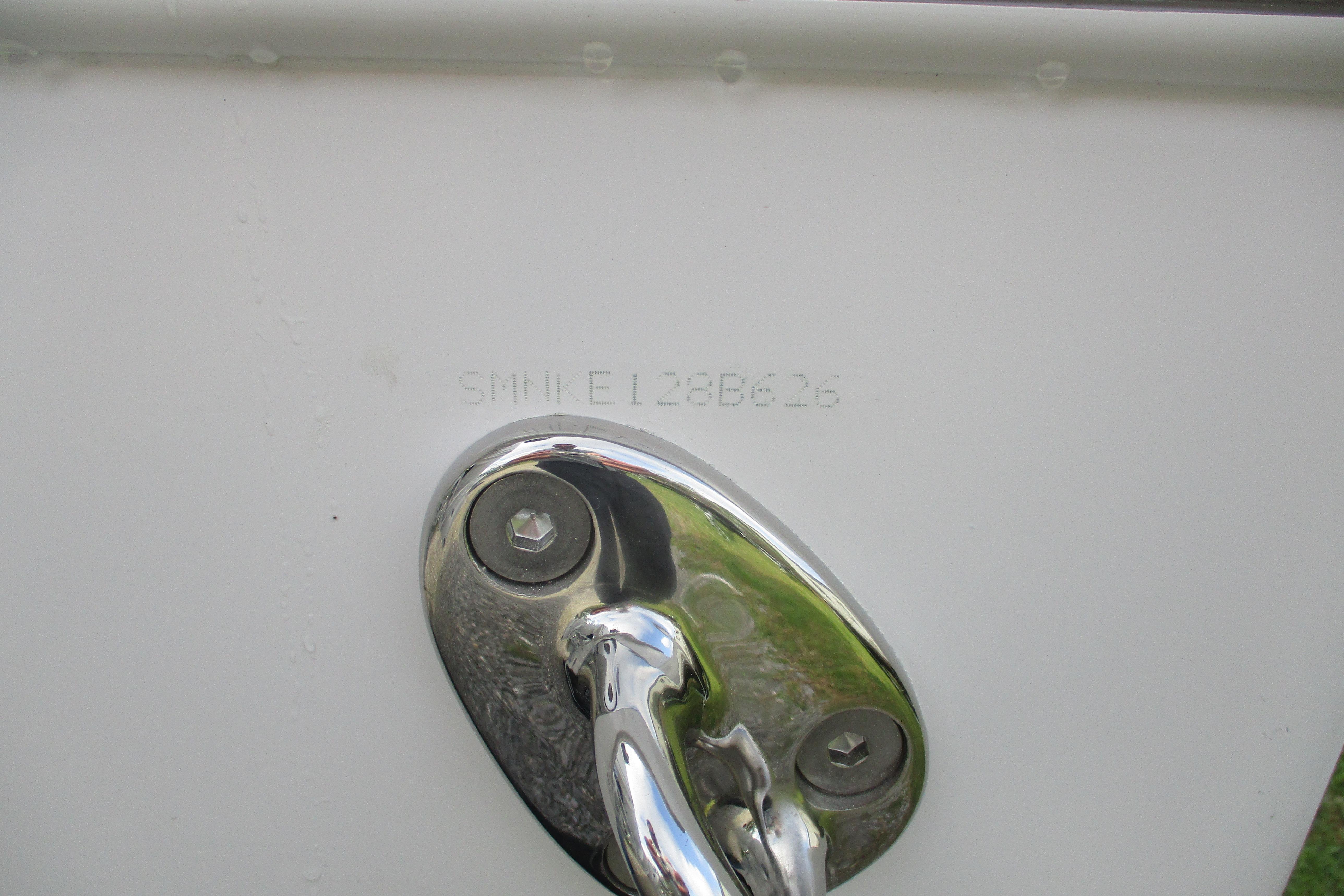 2026 Sportsman Open 302 Center Console boat hull identification number and chrome fitting.