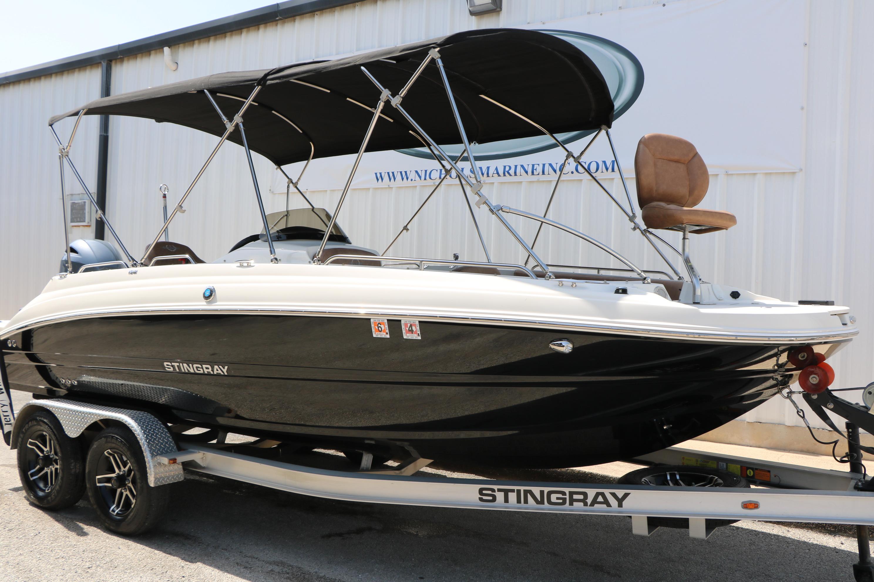 2022 Stingray 192 SC boat on trailer, featuring sleek design and canopy.