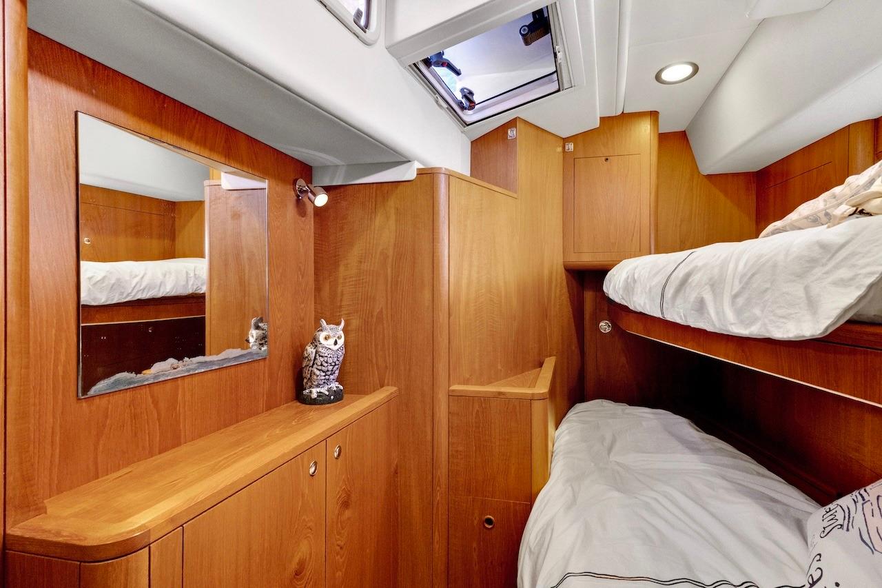 Cozy cabin interior of 2011 Southerly 57 RS yacht with wooden finish and bunk beds.