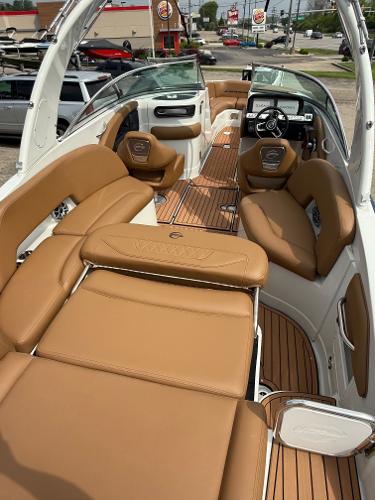 2025 Crownline 290 SS boat interior with tan leather seating and sleek design.